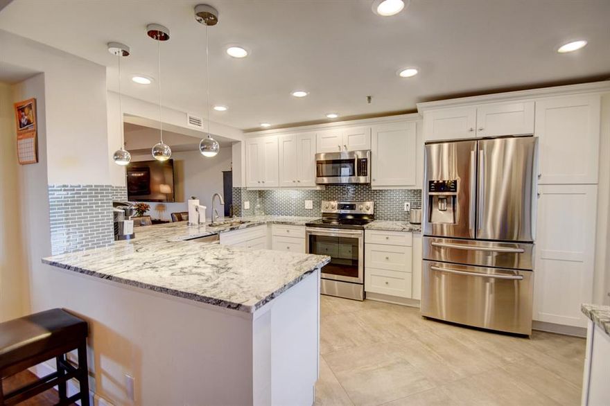 Beautifully renovated, this lovely 2/2 unit has under building assigned parking with gorgeous views of one of the top ten residential golf communities in the U.S. Fabulous new kitchen opened to living areas, with subway glass, new cabinetry, granite and stainless appliances (under warranty) , wine cooler. two newly renovated baths and laundry area ,with Italian design vanities,subway glass & tile. new ceilings, no  pop-corn,
new floors throughout, copper pipes, and lots of storage, Large tiled lanai overlooking the tennis pavilion,    additional balcony overlooking ninth fairway of one of two championship golf courses. All permitting and certificate of occupancy completed. motivated seller. Walk to clubhouse and all amenities.Make this your new home!