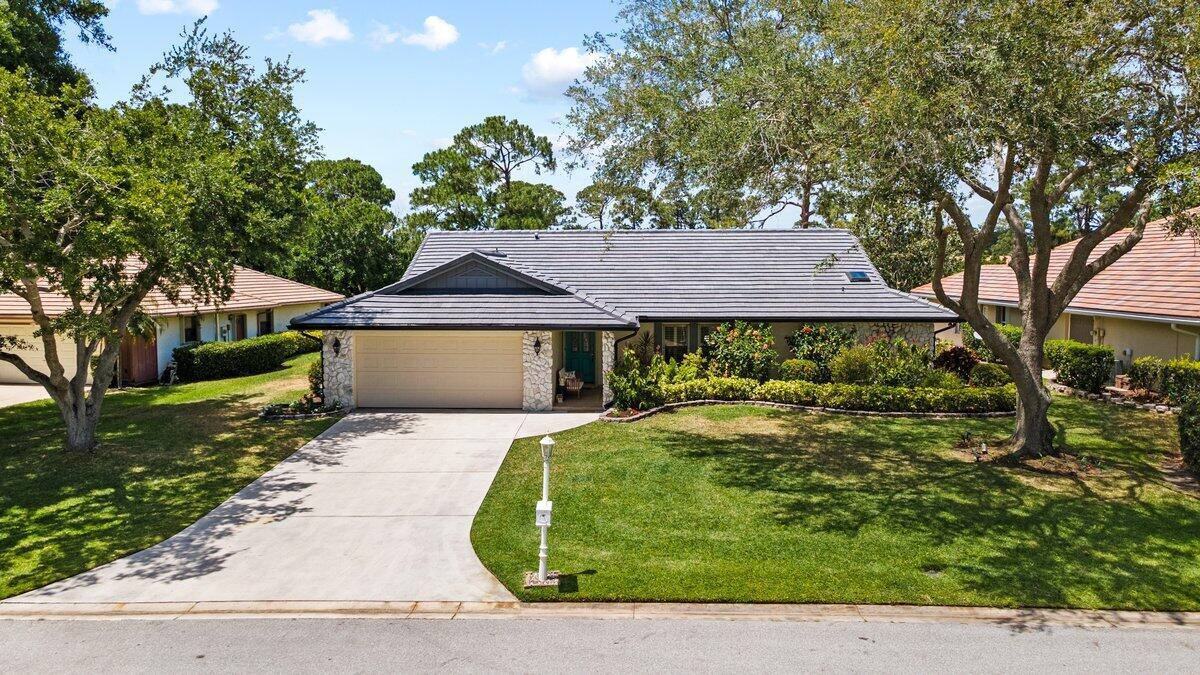 This golf course home boasts a 3-bedroom 2-bathrooms, plus Den, residence situated in Country Club Estates. Enjoy breathtaking views of the golf course from a spacious & a relaxing open patio and a large screened porch. The split floor plan offers convenient living.Trails golf course Membership to the Saint Lucie Trails Golf Club is optional, offering golf and social memberships. Residents can enjoy clubhouse amenities such as a pro golf shop, dining, pool, spa, embodying the essence of Florida country club living. Conveniently located in St. Lucie West near shopping and dining, this remarkable home offers an exceptional living experience that should not be missed!***NEW ROOF IN APRIL 2025******Master Spas Twilight Series - Negotiable***