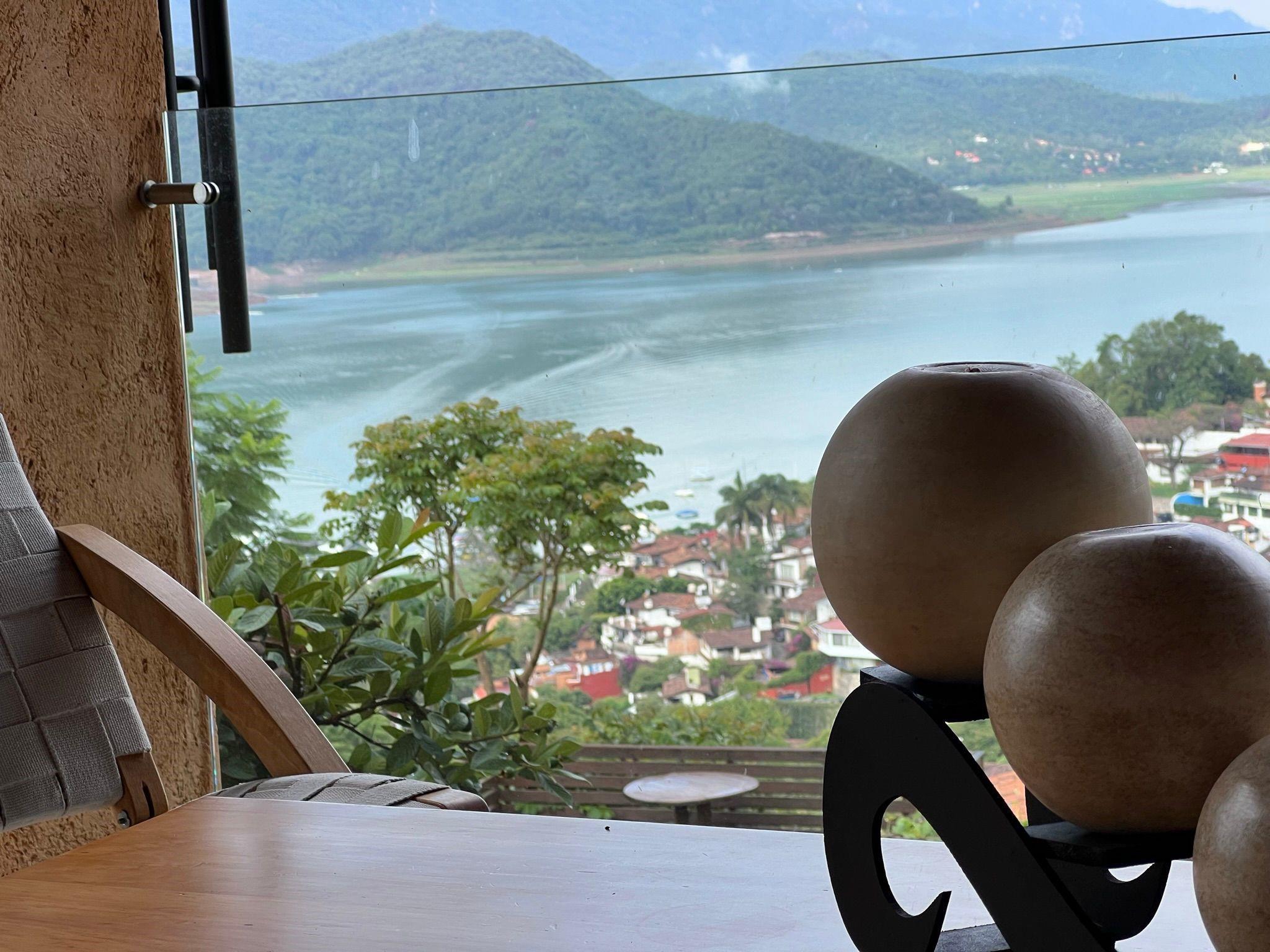 Lake view + pool + solar + 24/7 security — Warm, light-filled retreat in gated Condominio Horizonte, Santa María Ahuacatlán, Valle de Bravo. Featuring exposed timber beams, wood floors, and floor-to-ceiling windows framing panoramic lake views. The spacious living room with fireplace opens to two covered terraces, ideal for year-round lounging and entertaining. Includes 5 bedrooms, 6.5 baths, study, bunk room, and three parking spaces. Enjoy a pool, jacuzzi, orchard garden, solar panels, and mature landscaping for privacy. Perfect weekend escape or full-time residence. Built in 2004. Property located in Valle de Bravo, Estado de México, CP 51200, Mexico.