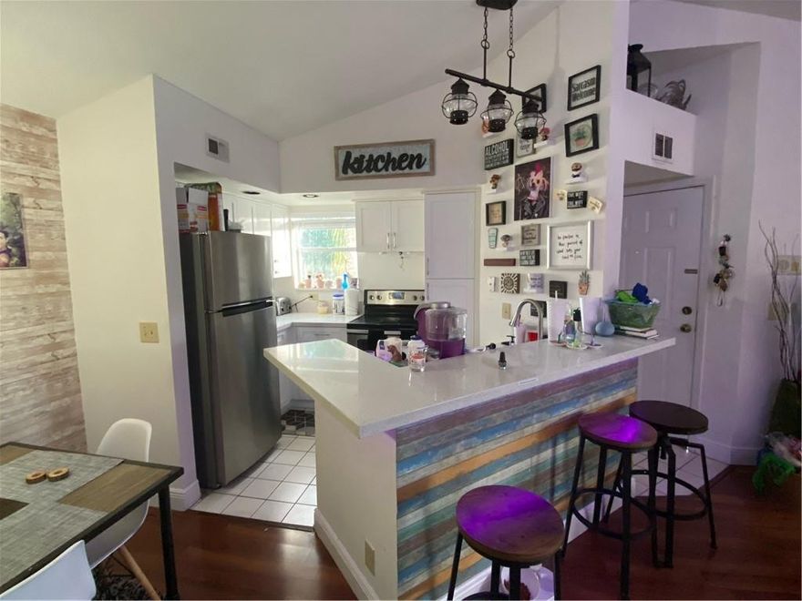 Fully remodeled unit with stunning water views at Isles at Lago Mar. From the vaulted ceilings to the wooden floors, this 2 bedroom 1 bath unit will exceed your expectations from the moment you walk in. Updated kitchen with stainless steel appliances and quartz countertops, and updated bathroom with the same modern design. Beautiful water views from the master bedroom and living area, through large windows that allow for plenty of natural light. Washer and dryer in unit. Steps from one of Isles at Lago Mar's pools and its clubhouse. This community also has tennis courts, lots of guest parking, an exercise room, golf course views, and more. Excellent location 2 minutes from major roadways including Flamingo rd and 595 and only 5 minutes from Sawgrass Mills.