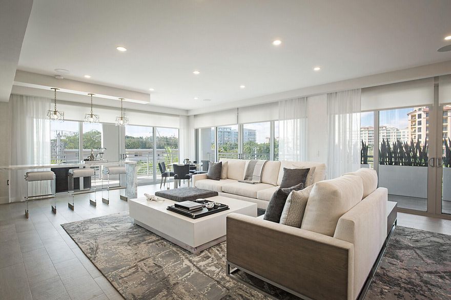 A home in the sky! Newly built in 2019, 327 Royal Palm represents the ultimate in luxury. Unparalleled elegance and modern comforts can be found in this expansive customized corner residence with wrap around balcony featuring an open floor plan with 3 bedrooms 2 and a half baths and a den/office. Thoughtfully designed and impeccably  furnished by Nikki Levy Interiors this one of a kind property is being sold furnished.   Exit the elevator directly into your own private foyer with a one of a kind pendant installation and a custom feature wall.  Porcelanosa wood grain tile runs throughout the residence. The grand living room is surrounded by floor to ceiling sliding doors that drench the home with natural sunlight and has multiple spaces for entertaining including a chic bespoke bar.  327 Royal Palm is the only building in the city of  Boca Raton that offers natural gas and that has a summer kitchen with a built in grill and sink on its balcony which is a whopping 536 square feet and has southern and western exposures which will provide the most gorgeous sunsets.  Even more impressive is the chef's kitchen which features a gas cooktop, two islands and Wolf, SubZero and Viking stainless steel appliances. An elegant dining alcove completes this spectacular kitchen. Adjacent to the kitchen is a den/office that is the perfect workspace or a quiet place to relax. A hidden door in the living room leads to the primary bedroom. This primary suite was thoughtfully designed and impeccably finished for the ultimate in relaxation.  A separate bedroom wing has two secondary bedrooms each with a walk in closet and a shared spa like bathroom with soaking tub and glass enclosed shower.  A powder room, laundry room and storage room complete the home.  Building amenities include a rooftop pool and deck, gym, 24 hour doorman, concierge, valet and 2 parking spots. Close to exceptional restaurants, shops, markets and the beach this is the ultimate in condominium living in east Boca Raton.