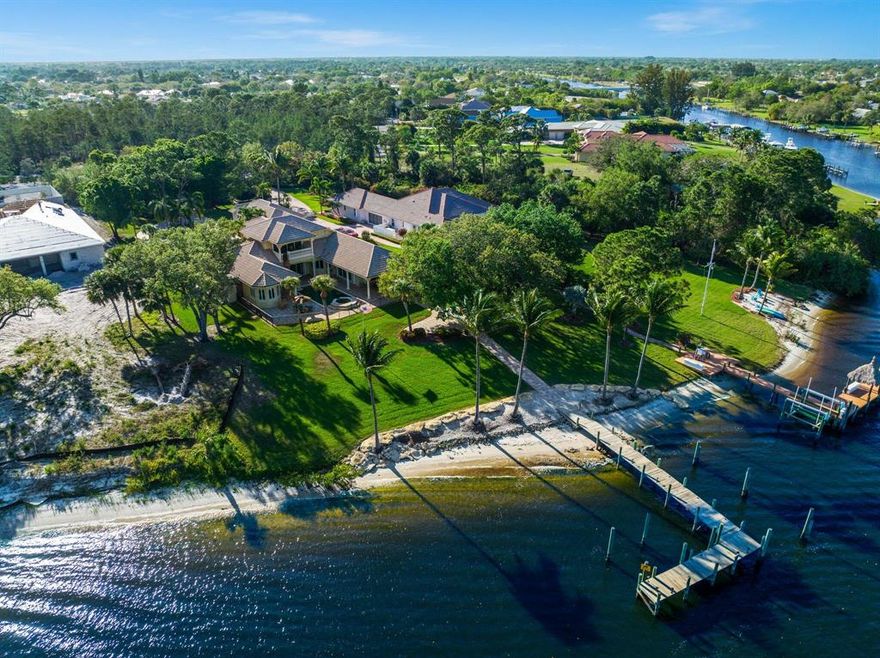 This WATERFRONT custom 7500+ sqft home is an absolute masterpiece with 5 bedrooms, 4 en-suite baths, and 3 half-baths with marble floors! DEEP Water, bring your yacht. Dock can accommodate 3+ boats & no wake zone! Gourmet kitchen featuring beautiful cabinetry, 23x30 w/ Viking 6 burner stove, double oven, 2 Bosch dishwashers, Miele coffee station, granite countertops, and subzero refrigerator! The elegant staircase leads to a 27x29 game room with bar, dumb waiter from kitchen, and marble floors! Step outside to a luxury resort setting with outdoor kitchen and 140ft of beachfront! Pool & Spa are heated, chilled + salt system! Perfect SE exposure to enjoy the afternoon shade and great breezes on the St. Lucie River! 3 new A/C, whole home generator, and 3 car garage!