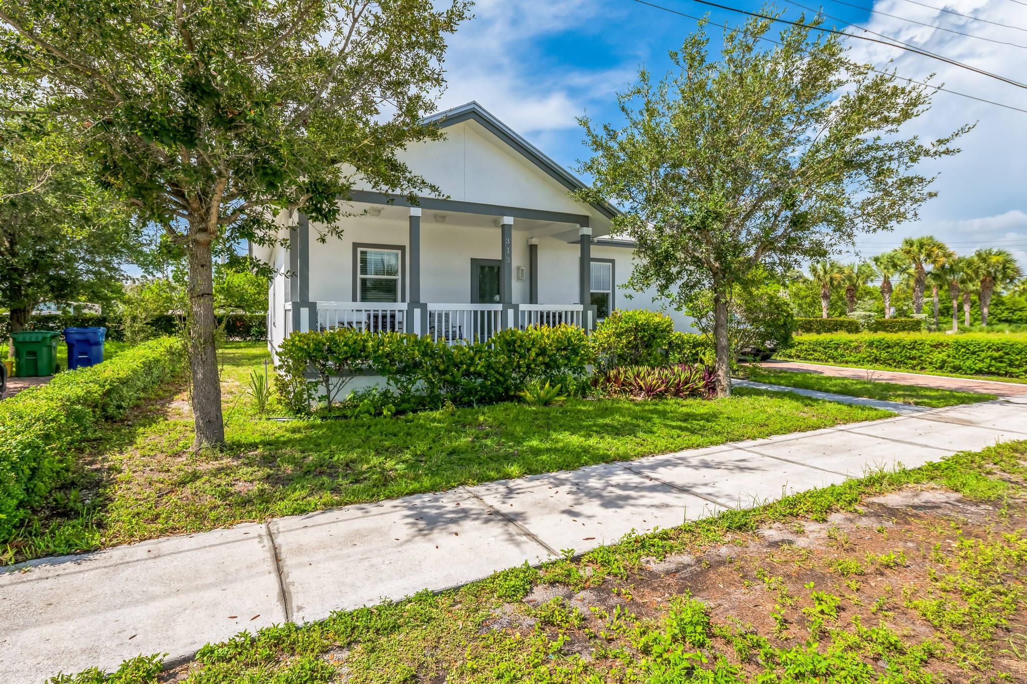 This beautifully updated home,built in 2017,was recently refreshed in 2025 with brand-new quartz countertops, modern appliances, fresh interior and exterior paint, and stylish lighting throughout. Featuring tile flooring throughout, spacious bedrooms with built-in dressers, and abundant natural light, the home blends comfort with contemporary elegance. The kitchen offers generous counter space and plenty of cabinetry; perfect for cooking and gathering. Ample closets provide outstanding storage throughout the home. Enjoy relaxing or entertaining on the large covered front and back porches, all set on a quiet, private street. Upgrades include a 2017 roof, impact-resistant doors and windows, and a wide paver driveway. Ideally located near the beach and marina! Schedule your showing today!