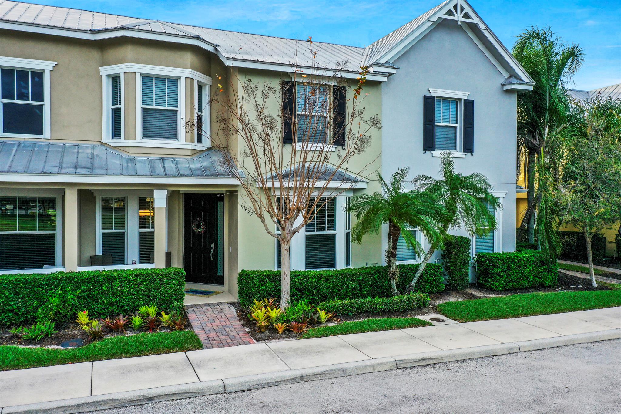 Move in Ready. Beautiful Townhouse in the heart of Tradition. Open layout. 3 bedroom, 2 1/2 bathroom with the Primary Bedroom downstairs. Large primary bath with dual sinks, shower. Walk in Closet. 2 car garage. Kitchen w granite counters overlooks den area. Formal DR & LR plus den. 2 bedrooms upstairs w/ full bath & loft area. Impact Windows. Front porch exposure overlooks the Lake & Green space. Private screened in patio. Easy access Community pool, club house and so much more. Home is conveniently located within walking distance to Tradition Town Square, shopping, restaurants. Hospital is close by. This home is furnished. Home can be purchased turn key - just move in.
