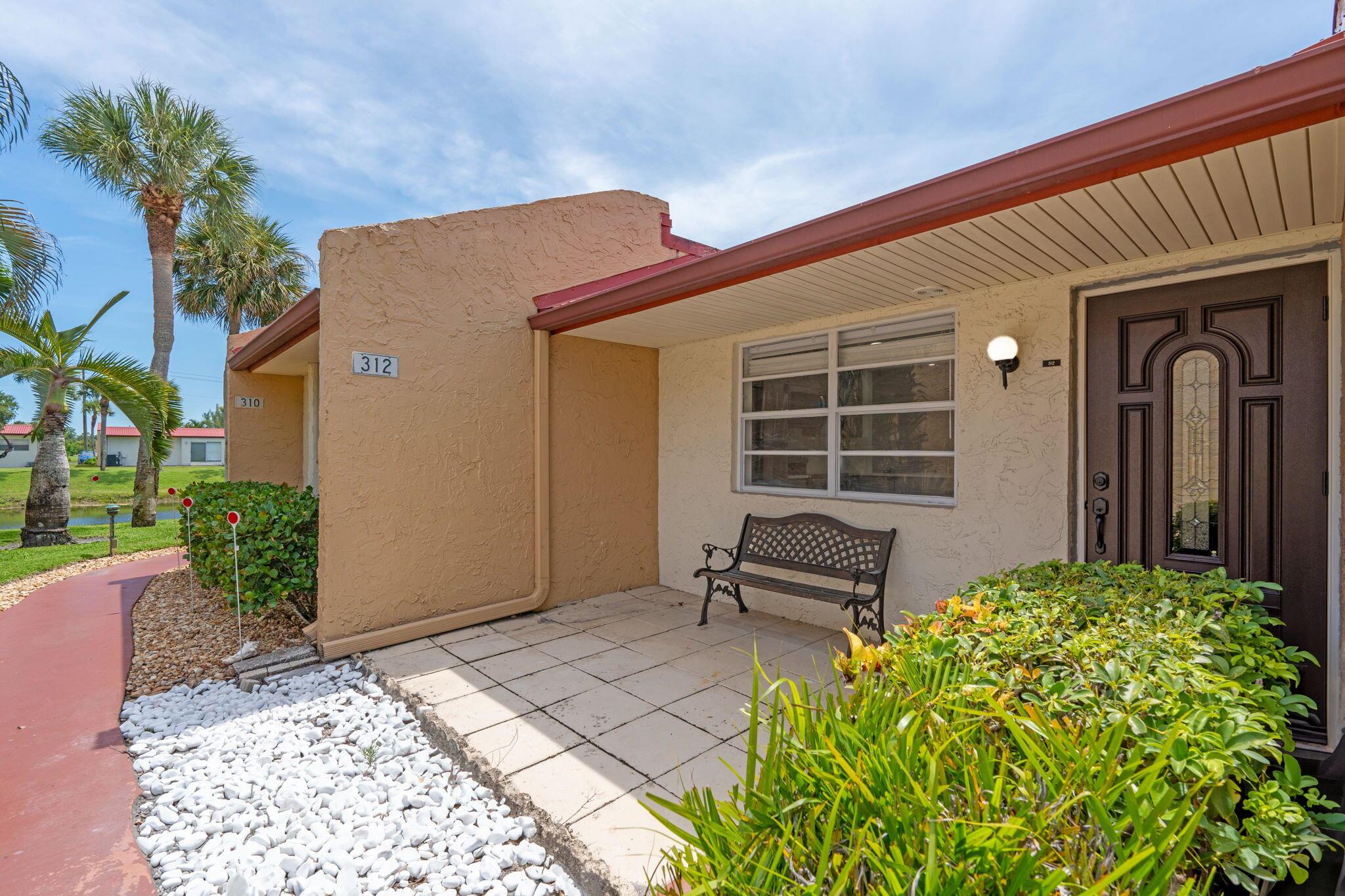 Welcome to this fully renovated 1st-floor condo in Golden Lakes 55+ gated community. Enjoy manned security, full amenities, and a prime location just minutes from vibrant Downtown West Palm Beach with its dining, shopping, and entertainment.This spacious unit features a west-facing waterfront view--perfect for watching the sunset from your screened back patio, complete with roll-down hurricane shutters. A rare front bonus patio adds even more outdoor living space. Inside, you'll find brand-new floors throughout, a stylish open kitchen with sparkling quartz countertops, stainless steel appliances, and a redesigned layout that flows into the dining area. Both bathrooms have been fully updated with new vanities, glass-enclosed showers, and modern fixtures.
