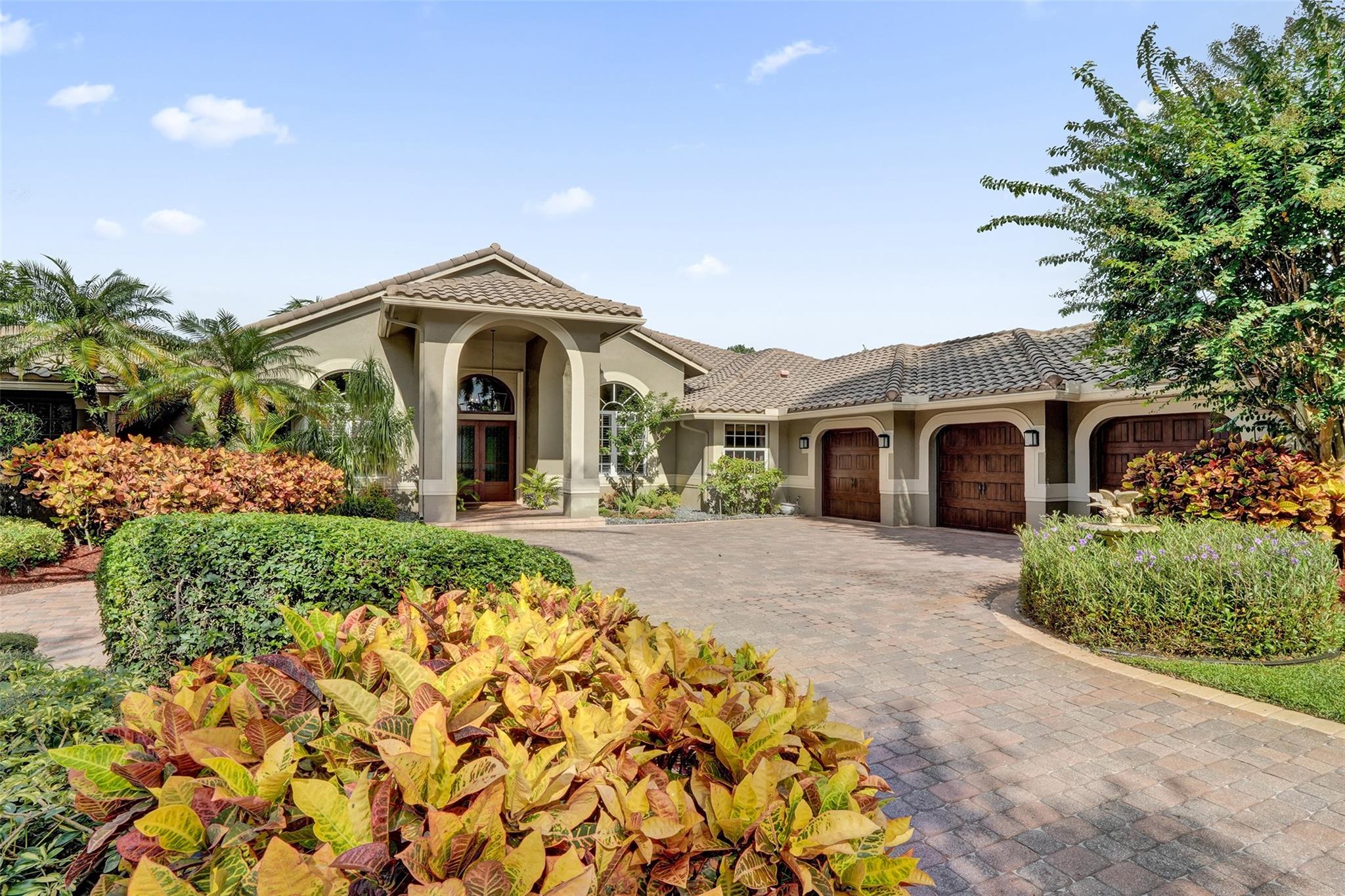 Step into refined luxury at this exquisitely renovated 5-bedroom, 4-bath estate nestled in the heart of Parkland. Designed for both elegance and comfort, this home boasts a sprawling open floor plan with porcelain tile throughout, sleek designer finishes, & a chef-inspired kitchen with solid wood cabinets, quartz countertops and top-tier stainless steel appliances. Soaring ceilings and impact glass windows fill the space with natural light, creating an effortless indoor-outdoor flow. Escape to your private tropical and lush retreat featuring a heated resort-style pool & spa both refinished in 2024. A 3-car garage adds convenience & curb appeal. Located in a prestigious community near top schools, this is the ultimate in South Florida sophistication & style. Excluding mirror in Cabana Bath.