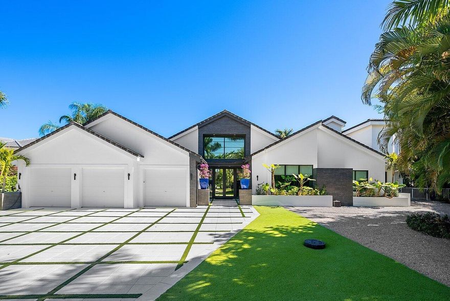 Completely designer 6 BD 5.5 BA in Devon Place with elevated finishes throughout, where rich dark accents create a sophisticated and inviting atmosphere. Set on a quiet cul-de-sac with great curb appeal, the home welcomes you into an open floor plan anchored by a striking main living room with high volume ceilings, floor-to-ceiling windows, and abundant natural light overlooking the pool, creating a bright, open centerpiece for the home. The statement kitchen spans the entire side of the living space and is thoughtfully designed for both everyday living and entertaining, featuring Levant custom cabinetry, a striking brown leathered granite island and full-wall matching backsplash, a large Sub-Zero refrigerator, a built-in Wolf coffee maker and microwave, an oversized pantry, and generous storage throughout. A dedicated dining area is seamlessly integrated into the kitchen layout, creating a natural gathering space for meals and conversation. French doors off the kitchen open directly to the pool, enhancing the home's effortless indoor-outdoor flow, while a beautifully detailed coffered ceiling adds architectural interest and elegance. Just off the living room, a full bar with a built-in cooler, ice maker, and separate sink creates the perfect entertaining hub. The primary suite is a true retreat with direct access to the pool, two extra-large walk-in closets, and a spa-inspired bath featuring warm wood finishes, two private water closets, and a spacious his-and-hers shower. An upstairs bedroom features an oversized designer bathroom with beautiful finishes and hand-laid stone in the shower, while additional downstairs bedrooms and a dedicated office offer flexible space for guests, work-from-home living, or multi-generational needs. Each bathroom throughout the home is uniquely designed with elevated finishes, creating a distinct and memorable experience in every suite. Outdoors, enjoy a private resort-style setting with a pool and spa, outdoor kitchen, multiple seating areas, and a cabana bath. The eco-friendly landscaping includes a grid-pattern turf design with Turkish marble accents, creating a low-maintenance yet striking backyard retreat.