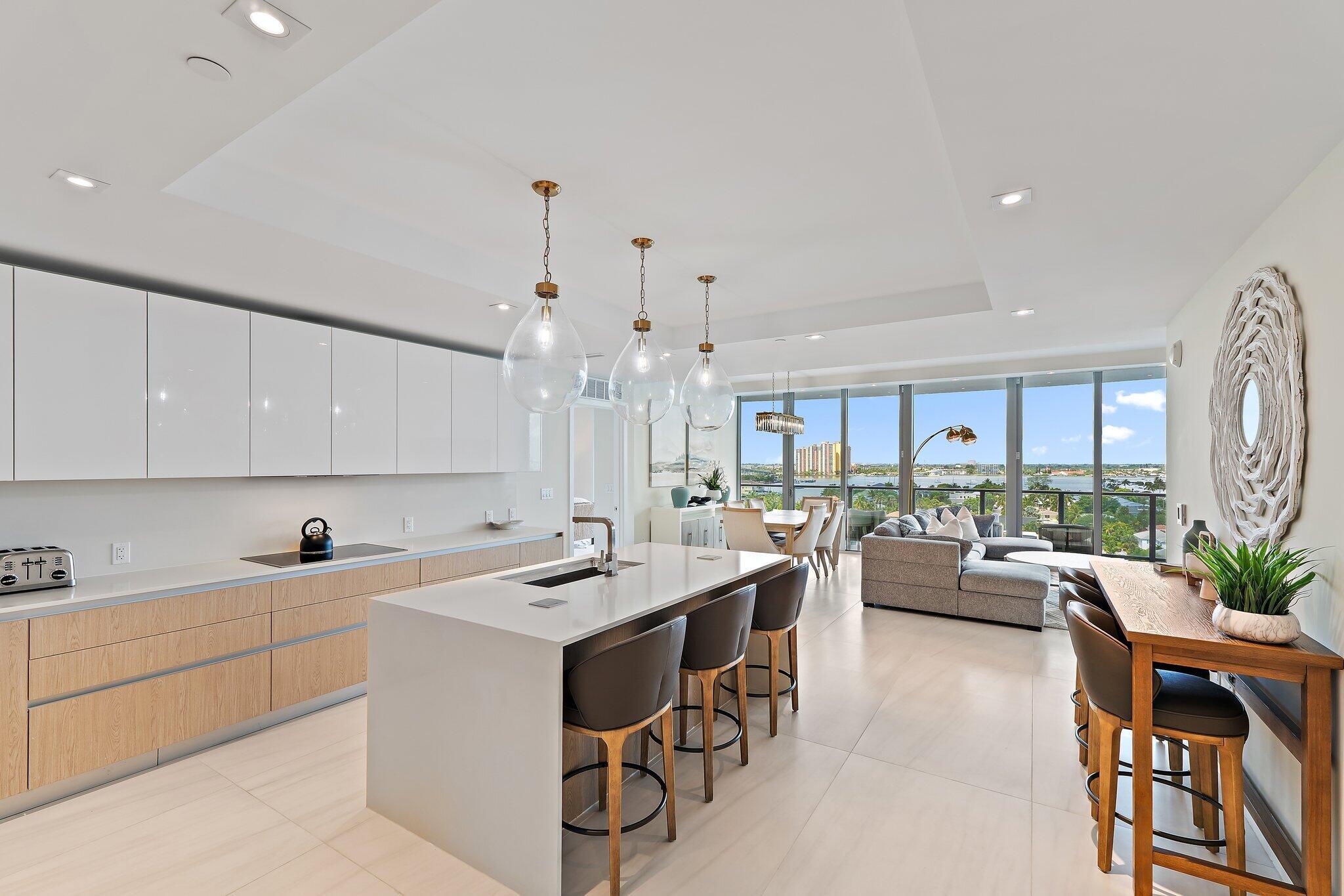 Ultimate luxury awaits on the 9th floor at Amrit Ocean Resort & Residences, a brand-new, health and wellness-focused resort on Singer Island. Now available for annual or seasonal rentals, this fully furnished, turnkey 2-bedroom, 2-bathroom residence offers breathtaking Intracoastal and ocean views from every room. This luxury oceanfront condo features floor-to-ceiling glass doors, an expansive 350 sq. ft. terrace, and an open-concept layout designed for seamless indoor-outdoor living. Enjoy stunning sunsets from your private terrace, creating the perfect setting for relaxation and entertaining. The gourmet European kitchen is equipped with custom cabinetry, quartz countertops, and premium Miele appliances, including a wine refrigerator.