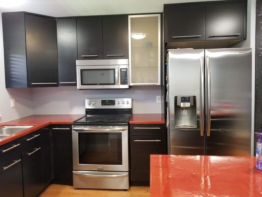 All ages.  New roof in 2024!  Buildings and walkways freshly painted in 2025!  Must see this beautifully remodeled 2 bedroom 2 bathroom condo with washer and dryer in the unit.  Features an open floor plan with neutral colors, stainless appliances, kitchen island, laminate and tile flooring, split bedroom plan, step-in shower in the primary bathroom, and covered screened balcony with garden and water views. Separate storage locker for your extras. Community offers a sparkling, heated pool, BBQ area, clubhouse and table tennis. Close to beaches, restaurants, shopping, and I95.  Just minutes from the excitement of Delray Beach's nightlife and restaurants. Must see!