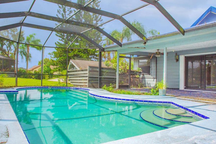 Located on a corner lot in the heart of Port St. Lucie, this frame construction pool home offers unique architectural details and incredible potential. The interior features cathedral-style cedar tongue-and-groove ceilings, two fireplaces (one in the living room and one in the converted bar/entertainment area), and a spacious kitchen perfect for future renovations and entertaining. The garage has been converted into a game room with a bar , adding flexible living space. Buyer to verify exposure all measurements are approximate NO SITE UNSEEN OFFERS