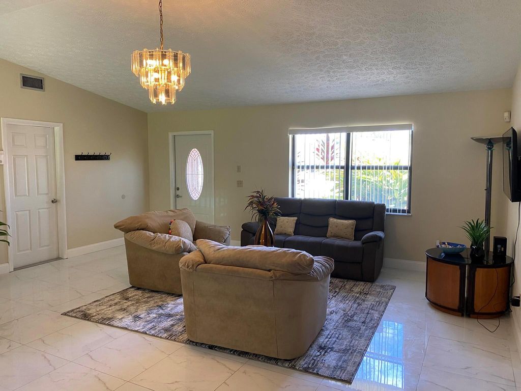 Photo of 2102 SW Burman Lane, Port Saint Lucie, FL 34984 (MLS # R11002603)