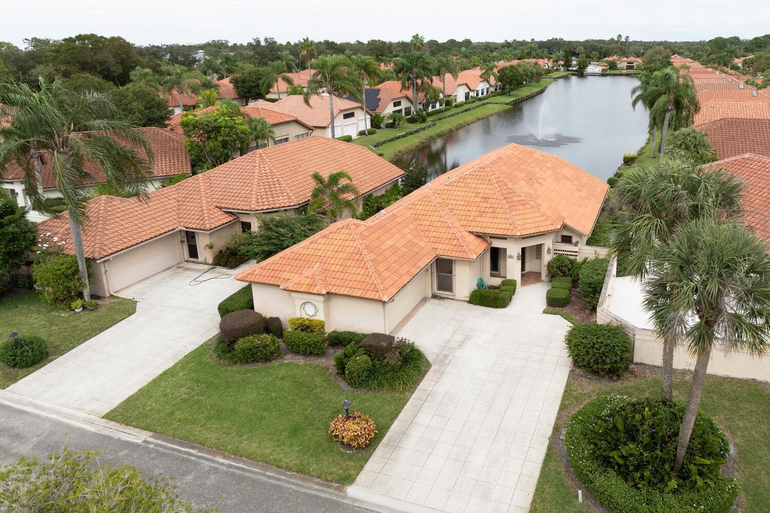 One of the best 3 lots in the entire community offering long range lake views. This beautiful home has been tastefully renovated top to bottom leaving you the simple task of moving in. The homes interior was fully renovated in 2021 plus a new roof, new a/c, and new hurricane impact garage in 2021 as well. As you enter the home you will quickly notice the beautiful vaulted ceilings, long range lake views, and wonderful open floor plan. The large living room shares the perfect space with the open kitchen which is detailed with white shaker cabinets, stainless steel appliances, and modern fixtures. Just off of the living room and dining area, is sliding glass door access to your backyard screened porch with the best lake views in the community and the relaxing sound of the fountain.