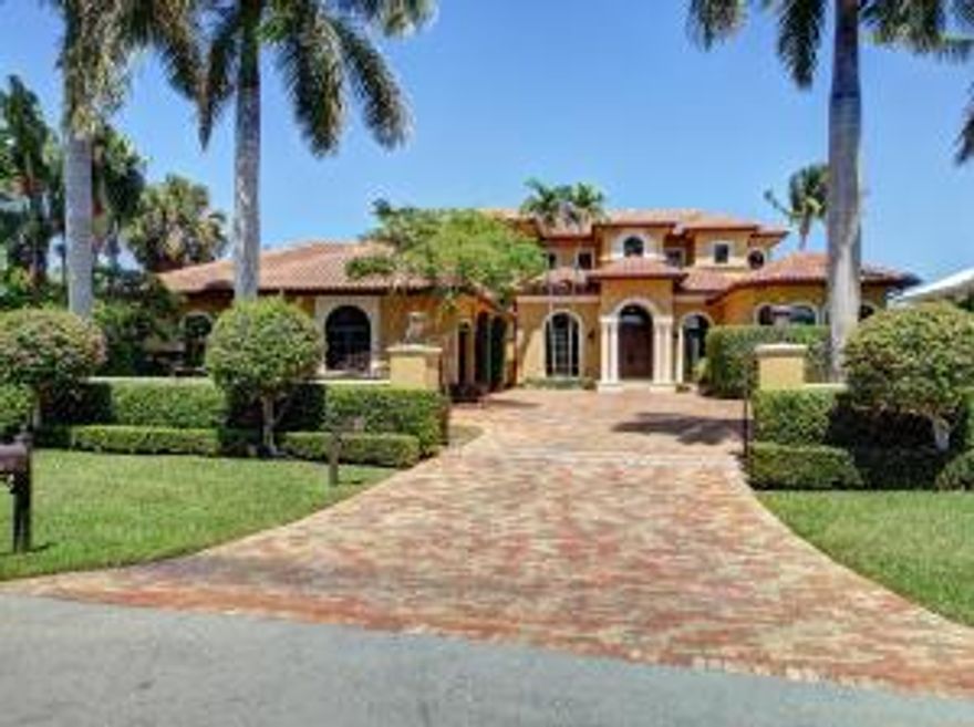 Elegant custom built Mediterranean  estate overlooking 102' of intracoastal waterway.Automatic iron gates open to a pavered courtyard,3 car garage,arched & columned main entry,plus private ofc/den entry.Over-the-top kitchen,bar area,wine room in same brick as kitchen ceiling.Exquisite finishes throughout. 2 bedroom suites plus a Master down, bedroom w/ balcony and 2nd Master up:each master with water views,sitting areas,luxurious bathrooms. Spacious loggia in tumbled travertine with fireplace,custom pool and spa. Luxury meets livability.