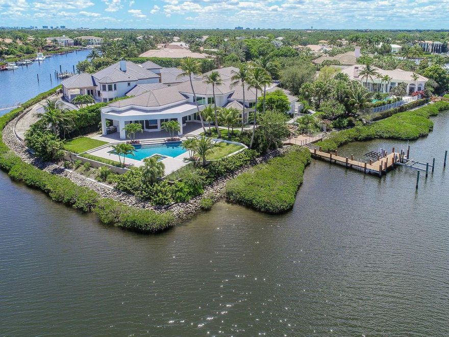 Newly finished Contemporary Estate Home on oversized waterfront lot featuring 273' of water frontage creating a 270 degree panoramic view! Located in a private cul-de-sac in prestigious Admiral's Cove of Jupiter, this palatial mansion features over 7,000 SF of living area with 6 bedrooms, 7 and one half baths, 3 car A/C garage, and guest suite w/separate entrance. Deep water canal provides protection for your vessel and allows for up to 150' yacht. Large custom Pool and Spa. Amazing cook's kitchen with 14' magnificent island, wet bar, custom cabinetry, walk-in pantry, built-ins throughout. Master bedroom and bathroom feature dual walk-in garden showers, jacuzzi tub and 2 walk in closets. So many features makes this a ''MUST SEE''. GOLF-TENNIS-BOATING ALL AT YOUR FRONT DOOR!