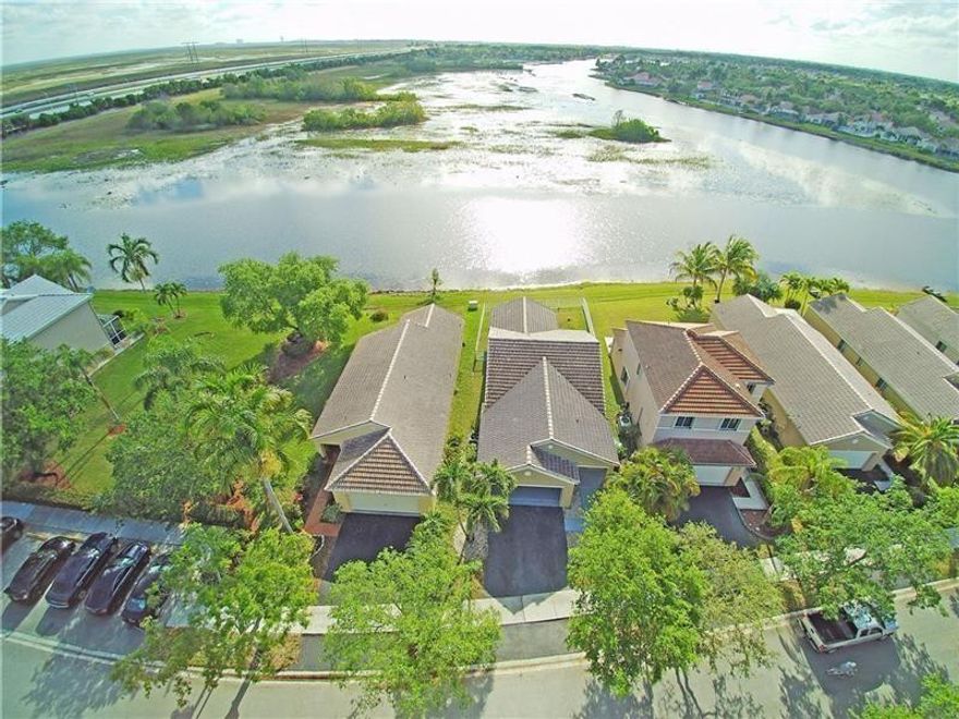 This is it!! Rarely available 3/2 waterfront home + 2 car garage available in San Messina with unbelievable eastern views of the lake!!! Super low HOA fees!! Granite kitchen and bathrooms with large format 48x48 tiles through out.. No carpet!! All stainless steel appliances!! Fully fenced backyard with plenty of room for the dogs to roam. Vaulted ceilings, huge Washer & Dryer, Split bedroom floor plan, formal living room, formal dining area, the list goes on... Excellent Weston school district!!Short walk to the community pool + kids playground!! Short drive to the beach!! ***Investor friendly*** Can rent right away.. No rental restrictions.