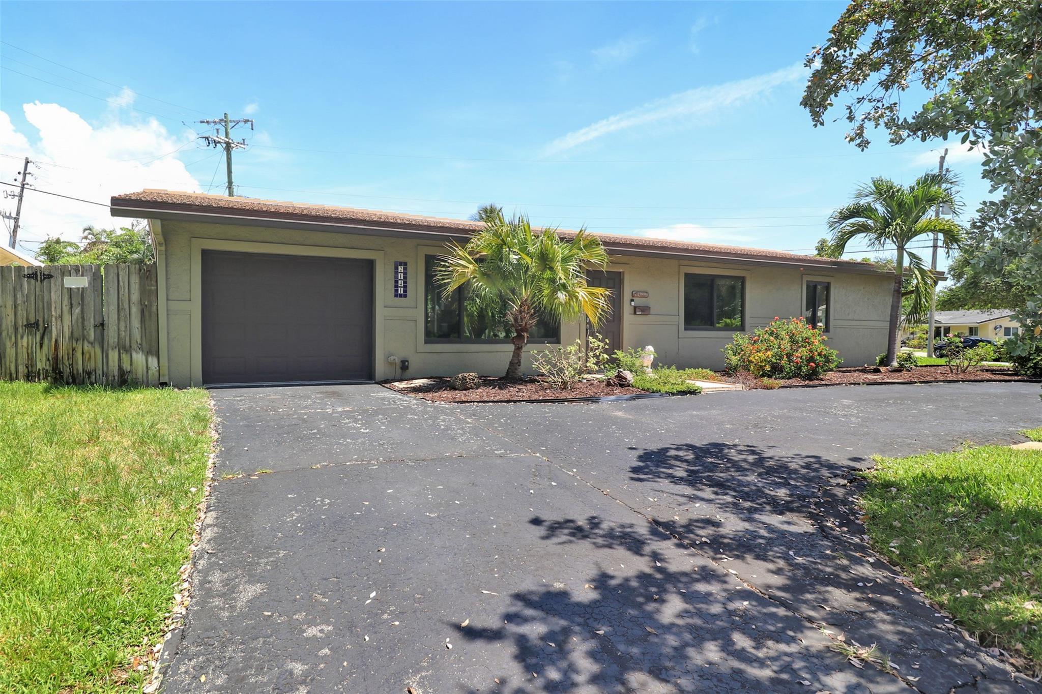 Pristine 3 bedroom-2 bath-1 car garage Single Family Home in Lighthouse Point. THIS HOME HAS IT ALL. New concrete tile roof (2021). Impact windows and doors (2021). Updated electrical panel & main + underground cable. NEW PVC plumbing to the street (No Cast Iron). 50 Amp generator Plug. A/C (2018). Resort style pool (2019) & paver patio. Gorgeous kitchen featuring two-tone cabinets, Carrara marble quartz countertops, mosaic glass backsplash & SS GE appliances. Freshly painted interior with new baseboards. New tile throughout including the master bathroom. Huge corner lot with circular drive + additional room for boat storage. Fenced in yard lined with Clusia offers tons of privacy. Ring Camera System & Alarm. WIFI Sprinkler System. This is the one!