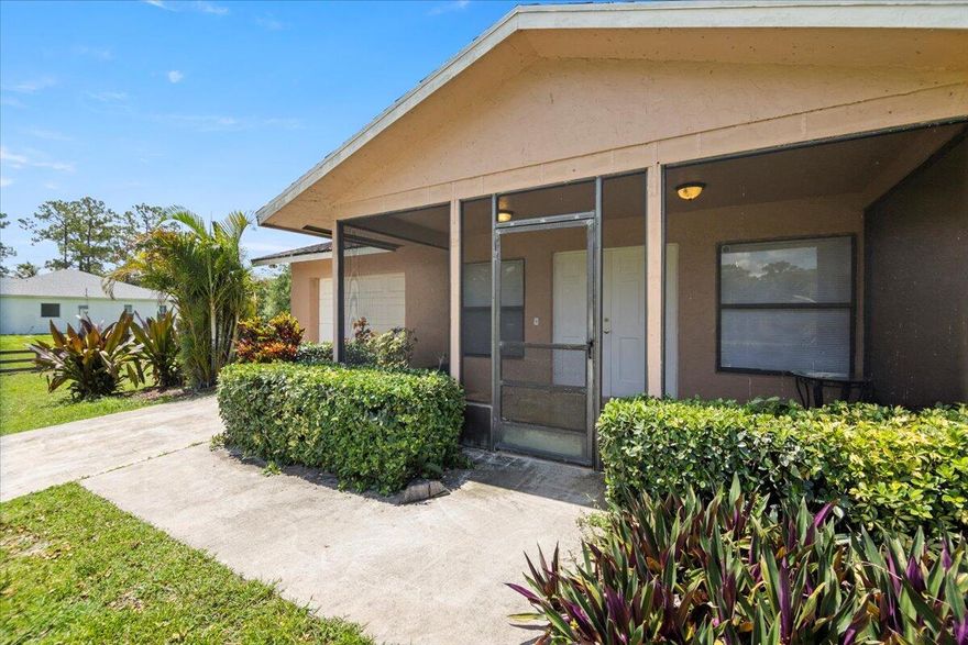 Situated in a prime location in Loxahatchee, this single-family home with 3 bedrooms and 2 bathrooms is a true gem. Boasting a desirable feature of no HOA fees, this renovated property offers a paved road access and is conveniently close to West Lake City. The home includes a delightful deck where you can enjoy the serene Florida greenery and take in the breathtaking view of the nearby pond. All of this is set on a spacious 1.15-acre lot, enveloped by lush tropical trees, creating a truly picturesque setting.
