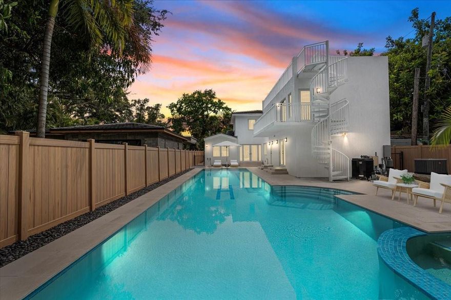 Luxurious 5 bedroom, 4 full bath home walking distance to Vizcaya in the East Shenandoah/The Roads area. Originally 1,515 & new addition an additional 1,600. This gated home with timeless comfort just minutes from all Miami has to offer. With nearly 3,115 sq/ft of living space, total 3,772 sq ft + 600 sq ft rooftop the layout offers generous proportions & impact-glass throughout for peace of mind. Inside you find open living spaces, chef’s kitchen & seamless indoor-outdoor flow. The backyard features a huge 64 x 14 pool/jacuzzi perfect for entertainment. Upstairs, 2 master bedrooms offer restful retreats, while downstairs are living areas & 3bedrooms. Gated entry & parking. Whether you're commuting Brickell, exploring the vibrant culture of Miami, this location connects it all & is a GEM.