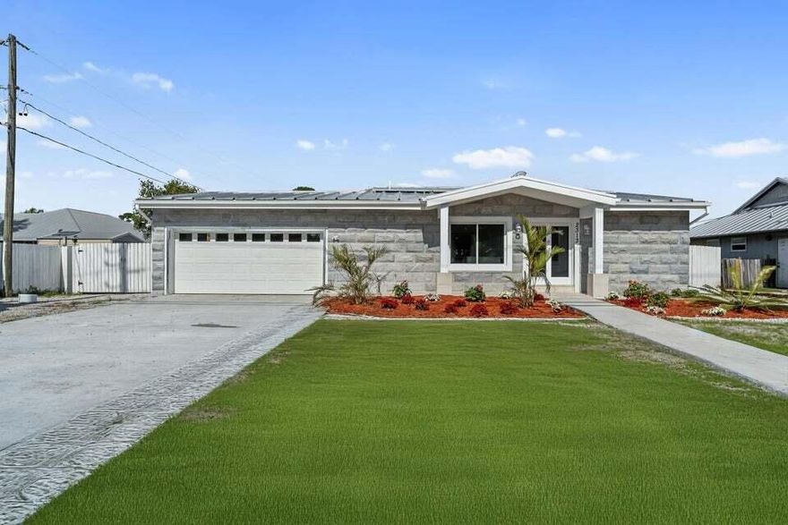 Welcome to your dream home in the desirable Port St. Lucie area! This exceptional 2025 new construction offers a perfect blend of modern design, luxury, and durability. With 2,110 square feet of thoughtfully designed living space, this single-family residence features 3 spacious bedrooms, 3 full bathrooms, and a converted, insulated 2-car garage with split AC. The side of the house has double door access for boats. Built to last, this home features a heavy-duty steel frame structure, providing unparalleled strength and durability while eliminating termite concerns.The metal roof is paired with an 8-inch steel frame roof, a 3mm membrane, and polyurethane insulation, ensuring energy efficiency, superior weather resistance, and long-term performance.