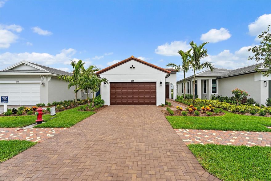 Experience luxury living at Rivella by Kolter Homes—new construction homes along the St. Lucie River, just minutes from the Atlantic beaches. Enjoy spacious, modern floor plans, resort-style amenities, and peaceful natural surroundings. Perfect for buyers seeking comfort, style, and an active coastal lifestyle in a prime Florida location. Stunning Spanish-style exterior Caroline, paired with west-facing lake and preserve views that capture golden hour beautifully. Offers 3 beds/2 baths, and a versatile flex space. Kitchen featuring warm, on-trend finishes and a microwave/oven wall combo. A 5' privacy wall pre-plumbed for a future summer kitchen makes outdoor living easy to customize.