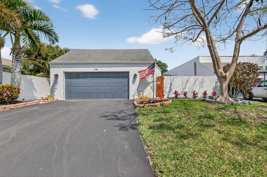 Light and peaceful move-in ready home in an all-ages community featuring two spacious primary suites, each with its own private bathroom—ideal for guests or flexible living. Enjoy a two-car garage plus an oversized four-car driveway. A deeded lakefront property is included, offering access to the water and added value. Don't miss this unique opportunity! Prime location close to Atlantic Ave. All-age community with no dog breed restrictions. HOA increases are capped at no more than 5% per year.   Recent updates include water heater (2022) with a 5-year warranty, A/C (2024) with a 10-year warranty, roofs (2016 & 2023), kitchen (2022), water filter and softener (2023), and washer/dryer (2025). Exterior features include a 220V connection for a jacuzzi.