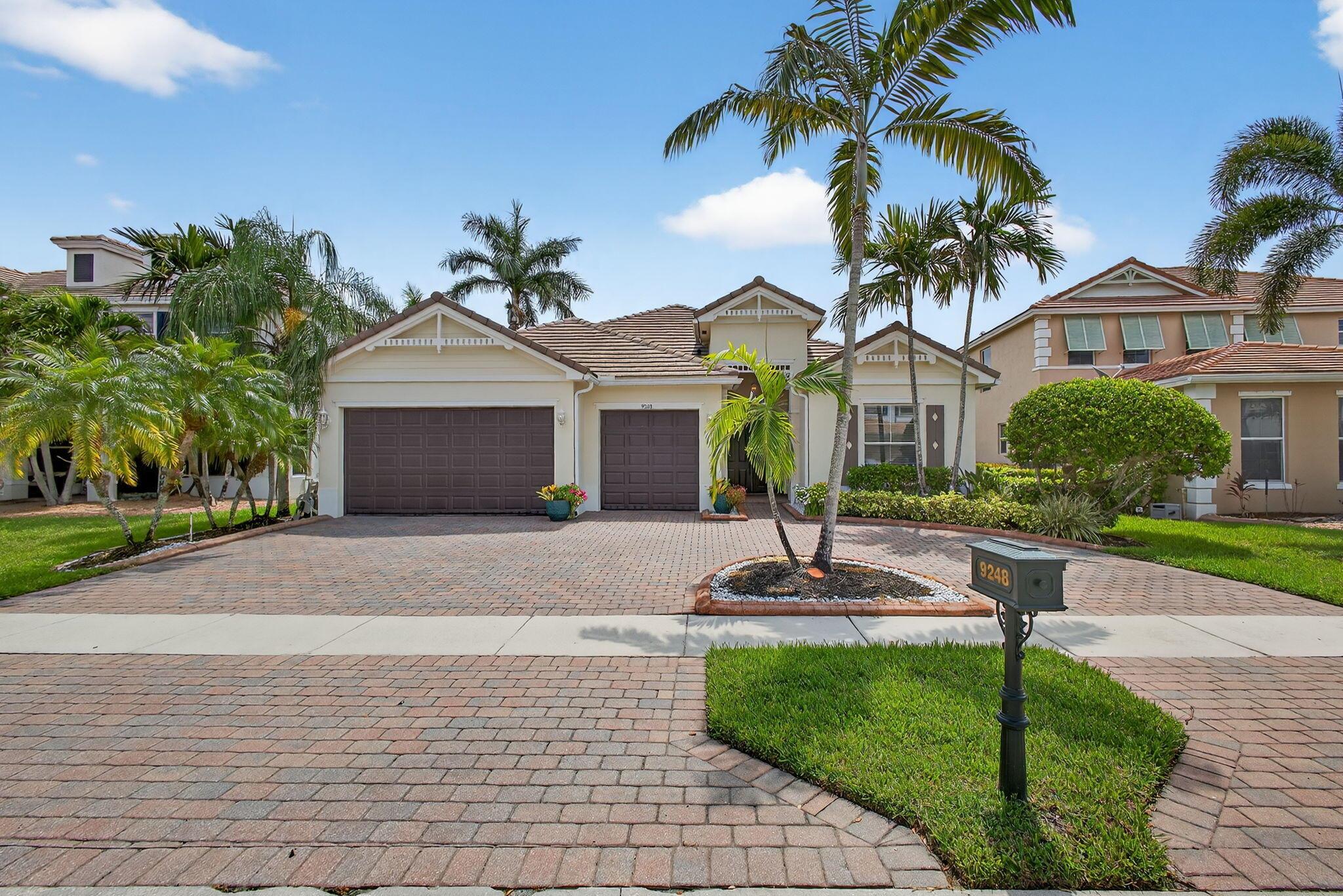 Welcome to this impeccably maintained 5 bedroom, 3 bathroom, 3 car garage estate, ideally situated on a private cul-de-sac in the exclusive Bay Tree enclave of Palm Beach Plantation in Royal Palm Beach, Florida. This elegant lakefront residence offers a private pool, tranquil water views, and exceptional curb appeal with a circular brick-paver driveway, manicured tropical landscaping, and an oversized garage. Recent upgrades include a 2023 roof, 2 A/C units installed in 2021, and a hot water heater from 2015. The roof was professionally power washed in July 2025, reflecting the home's meticulous upkeep and move-in-ready appeal.