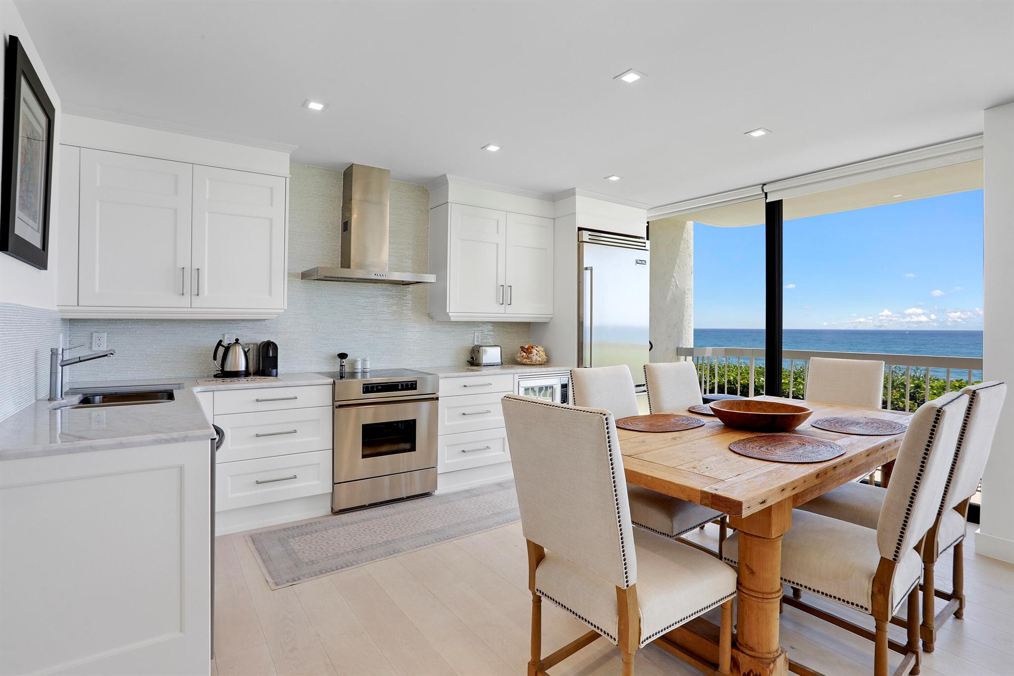 Expansive oceanfront views from this pristinely renovated three bedroom, two and a half bath second floor corner condo unit with full wrap-around balcony! Take in the extraordinarily wide range ocean views from the living room, kitchen, all three bedrooms and the spacious balcony with loungers and outdoor dining table. Be lulled to sleep with the soothing sounds of breaking waves on the shoreline from each room, offering balcony access.Classically designed for comfort and warmth this welcoming, fully furnished turnkey condo unit boasts new wood flooring throughout, a bright and open updated eat-in kitchen with quartz countertops, custom cabinetry, stainless steel appliances and impact windows and sliders throughout. This unit offers a laundry room with washer and dryer. Relax ...