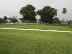 Beautifully kept villa, wood floors in rooms and living room, tiled kitchen, view to golf course, close to everything, wonderful community, across from pool area.