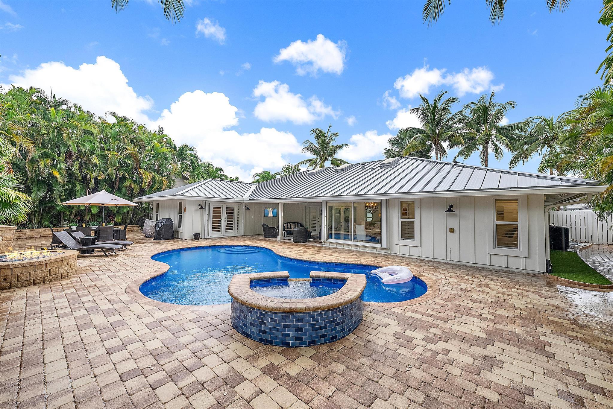 Just bring your bathing suit and toothbrush to this elegantly re-imagined, completely remodeled and furnished coastal inspired beach escape. This homes transformation was focused on opening the space and transforming the home to a elegant beach retreat. The new living area includes a vaulted family room with shiplap, beam ceilings, and board and a batten focal wall . A large designer kitchen with custom micro shaker cabinetry was designed by Zimmermans kitchens. The beautiful, expansive island with luxury appliances and quartz counters makes perfect for entertaining and family gatherings. The Primary suite was redesigned with a larger bathroom and closet area. The spa-like bathroom is an oasis with a luxurious shower, a free-standing soaker tub, upgraded fixtures and vanity.