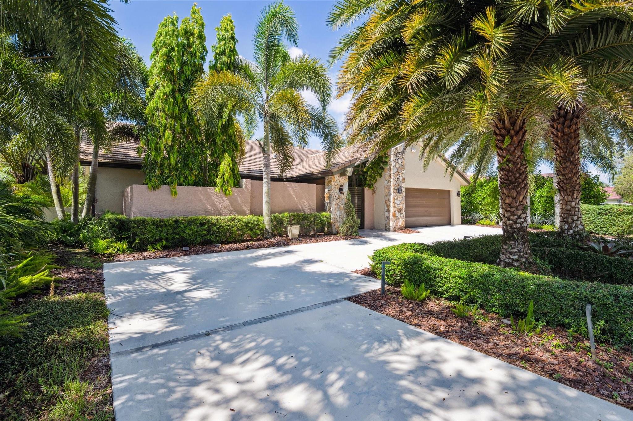Incredible location, unmatched setting with rare double waterfront views in Jacaranda Lakes! From the moment you arrive, the striking curb appeal, circular driveway, and professionally designed landscaping set the stage for this architect’s own 4BR/2BA residence. Step through the charming, gated courtyard and take in serene views of both a tranquil canal & lake from nearly every room. This home stands out w/dramatic vaulted ceilings, Italian porcelain flooring, California Redwood beams/paneling. The gourmet kitchen is equipped w/Jenn-Air appliances, Caesarstone countertops & solid wood cabinetry. Special features include skylights, accordion-hurricane shutters, 2-zone A/C, & a 2013 concrete tile roof. Lush landscaping & a peaceful waterfront setting make this home truly exceptional!