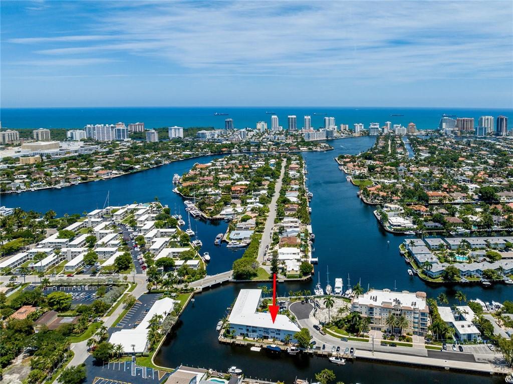 This stunning bright furnished custom designed 2 bedroom condo in Fort Lauderdale's most classic mid-century boutique hidden gem Burton Point located at the north end of famous Hendricks Isle is framed by an unobstructed panoramic backdrop of endless boat parades & water views from every room. Enjoy best of both worlds from early sunrises to late sunsets right from your own balcony. Impact doors and windows. Complimentary Washer/dryer on each floor. Elevator. Land lease (40 years left) included in the low maintenance fees. No leasing. 1 deeded parking. No dock. Very well maintained building. 40 year recertification done. New roof. Cast iron pipes changed. Additional storage. New seawall. Seller paid all pending assessments. Minutes walk to famous Las Olas Blvd & Beach. Easy to finance.
