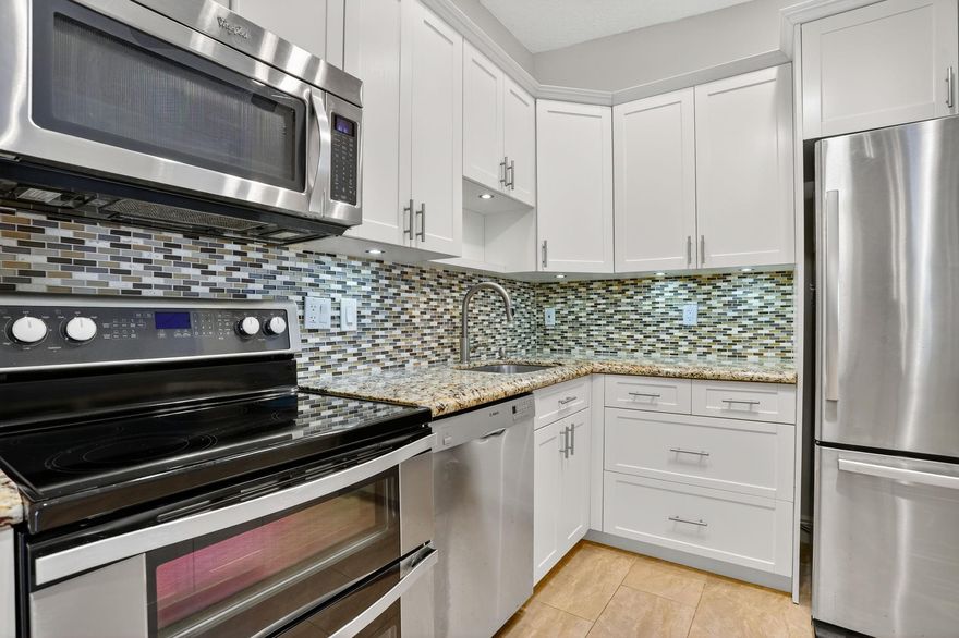 Welcome to Ashmont, within the amazing Kings Point Community. This beautifully renovated, corner unit is located on the 2nd floor. The tastefully designed open kitchen features stainless steel appliances, and a double oven perfect for any at home chef. View the pool from your spacious master suite with a large walk in closet and brand new flooring. New Water Heater(2025), AC (2020), Roof (2020). Washer/Dryer with plenty of storage space located on the expansive patio. Located just steps away from the community pool. HOA includes Water, Trash, Internet and Cable w/ HBO & Showtime. Kings Point Tamarac is a homeowner's dream come true. This active community is complete with state-of-the-art performing arts theater, cinema, fitness center, tennis & pickle ball, indoor/outdoor pools & spa, Billiards room, arts & crafts, air conditioned shuttle buses, and endless clubs and social events. A vibrant, resort-style community designed for active, fun-loving adults!