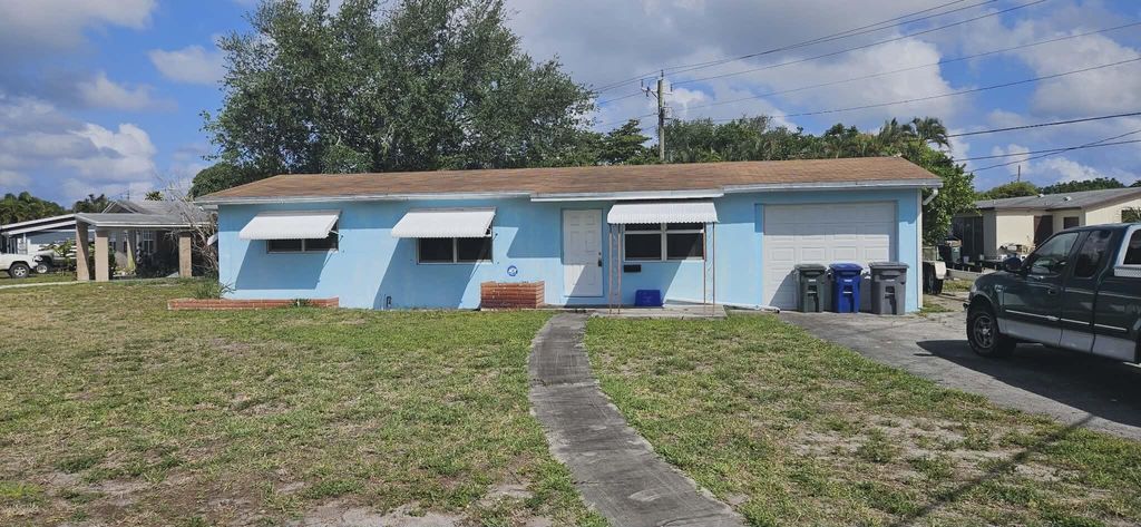 Photo of 860 W Jasmine Drive, Lake Park, FL 33403 (MLS # B26024553)