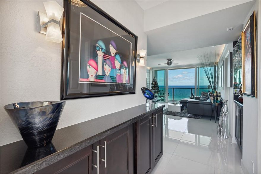 COME TO PARADISE! Gorgeous one-bedroom, 1.5-bath oceanfront condo with panoramic Atlantic views from every room. High-end finishes include granite countertops, porcelain tile floors, and top-of-the-line Frigidaire Gallery appliances. Interior highlights: dry bar, wine cooler, dual sinks, spacious walk-in closet, full-size washer/dryer, plus newer A/C and water heater. Building amenities feature a heated pool, BBQ area with dining, clubhouse, gym, direct beach access, and nearby Deerfield Beach International Pier. Ideally located near Boca Raton and within walking distance to supermarkets, restaurants and the boardwalk, this unit epitomizes luxury coastal living.