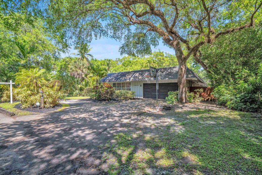 Welcome to this expansive, light-filled residence offering over 4,200 sq. ft. of beautifully designed living space. Situated on a rare oversized 16,000+ sq. ft. lot, this 4-bedroom, 3-bathroom pool home blends comfort, elegance, and privacy. Soaring ceilings and an abundance of natural light enhance the home's open feel, while the formal living and dining rooms create the perfect setting for both refined entertaining and everyday living. At the heart of the home, a serene courtyard featuring a tranquil koi pond provides a unique focal point and a peaceful escape, seamlessly bringing the outdoors in. The thoughtfully designed layout offers spacious bedrooms and inviting living areas, all with a natural flow throughout. Step outside to your private backyard oasis complete with a pool and e