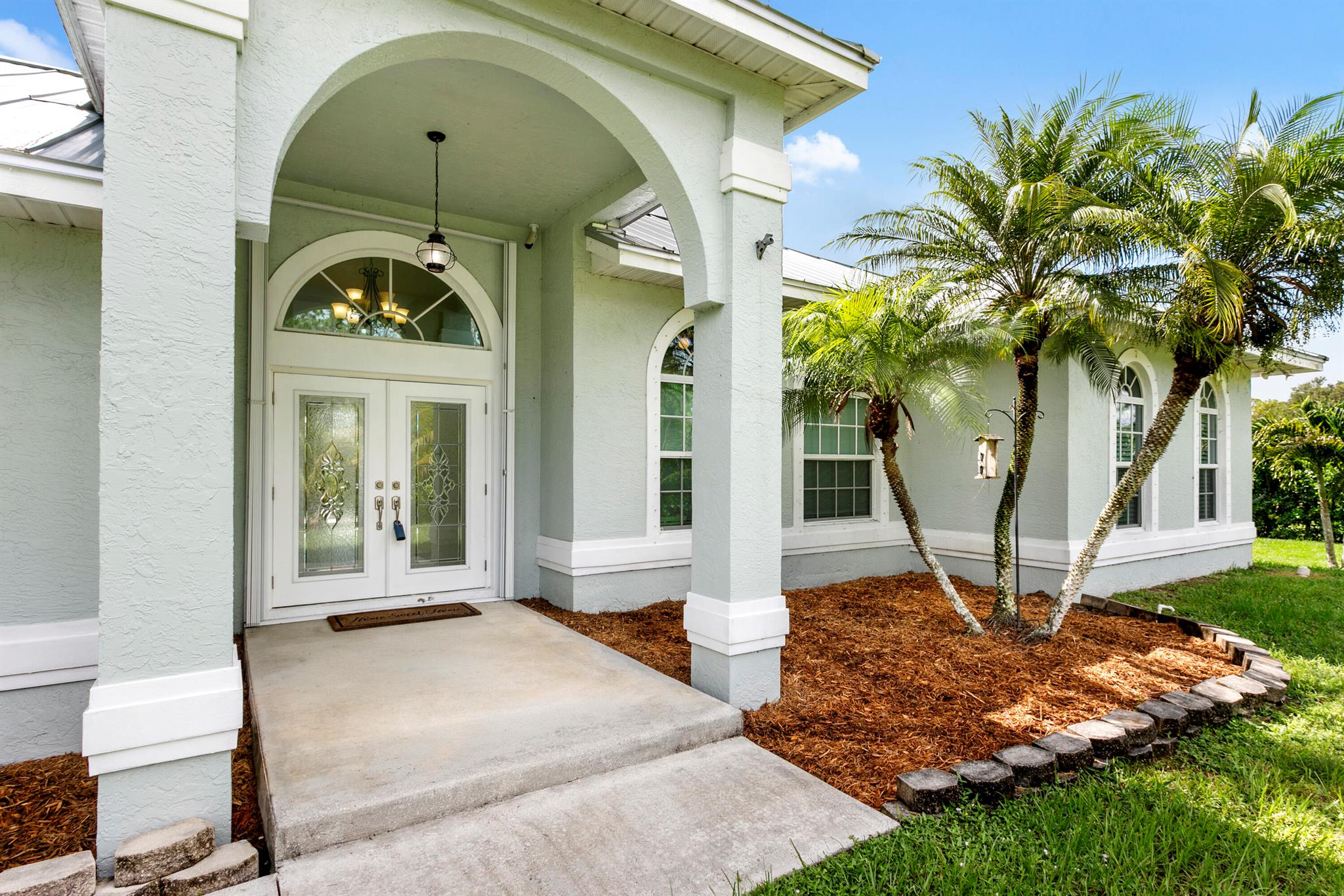 If you're looking for an amazing Key West style pool home, look no further than this stunning house with a den. Located on paved road ,1.39 acres fully fenced with huge privacy hedge and Generac full house auto generator. Not only are the windows, sliders and doors impact but there's also accordian shutters. This amazing home features tiled floors in the living area and Aqua Guard laminate flooring in all 3 bedrooms and den. the kitchen features Frigidaire stainless appliances , breakfast nook and breakfast bar. Main bedroom has his/her walk in closets and bathroom has his/hers vanity and separate soaking tub. Guest bedrooms are generously sized. Utility room has newer top load W/D ,and shelving. Step outside to your private oasis with a kids playset and pool. Metal roof 2021. Security