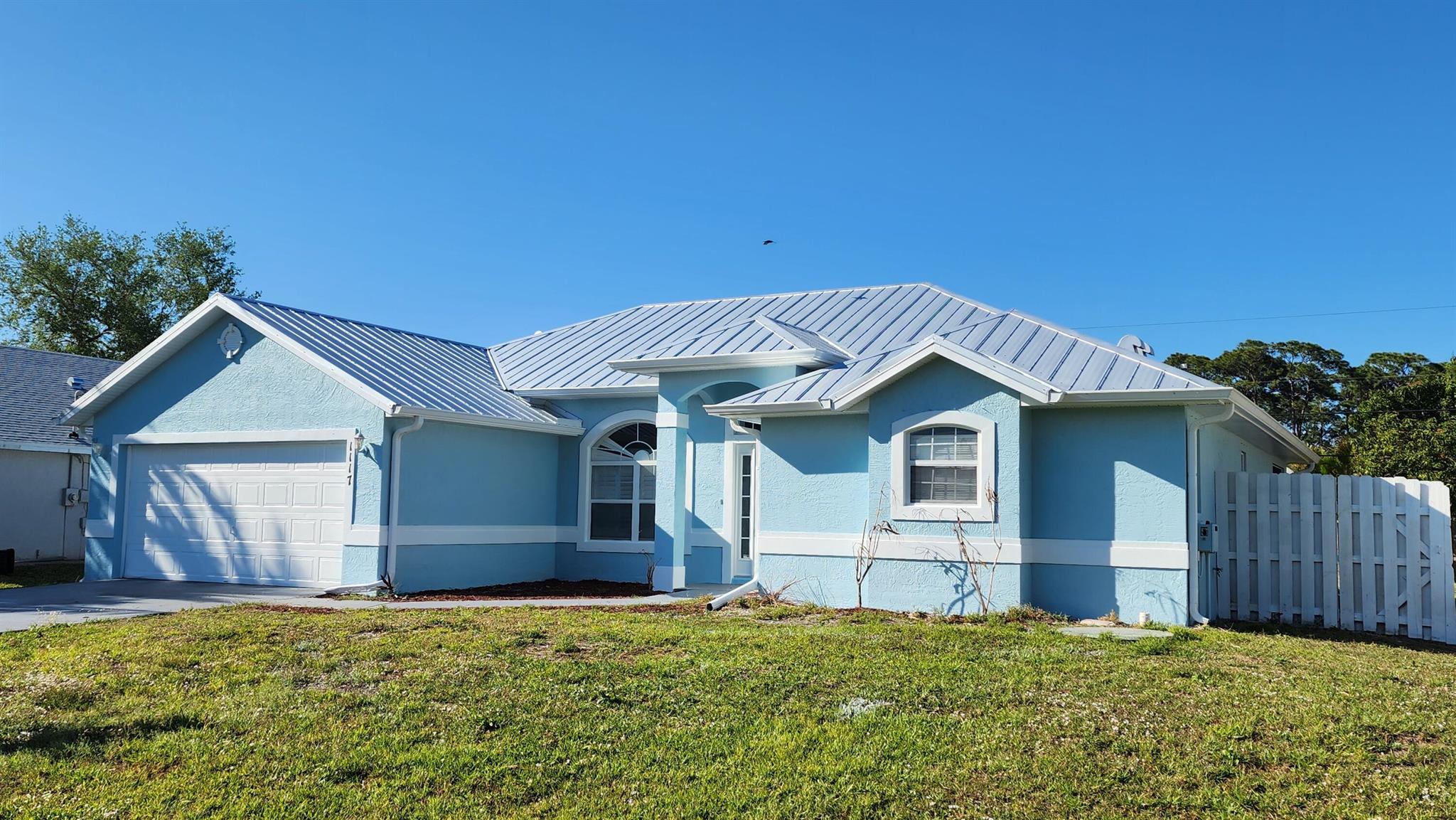 Spacious 4 BR 3 BA 2 CG CBS home in western PSL. Formal dining, living, and family room. Fenced yard, screened porch. New exterior paint. New metal roof in 2024. New AC in 2024. New HWH in 2022. Great location close to shopping and schools, only minutes to crosstown parkway, and the St Lucie West PUD.