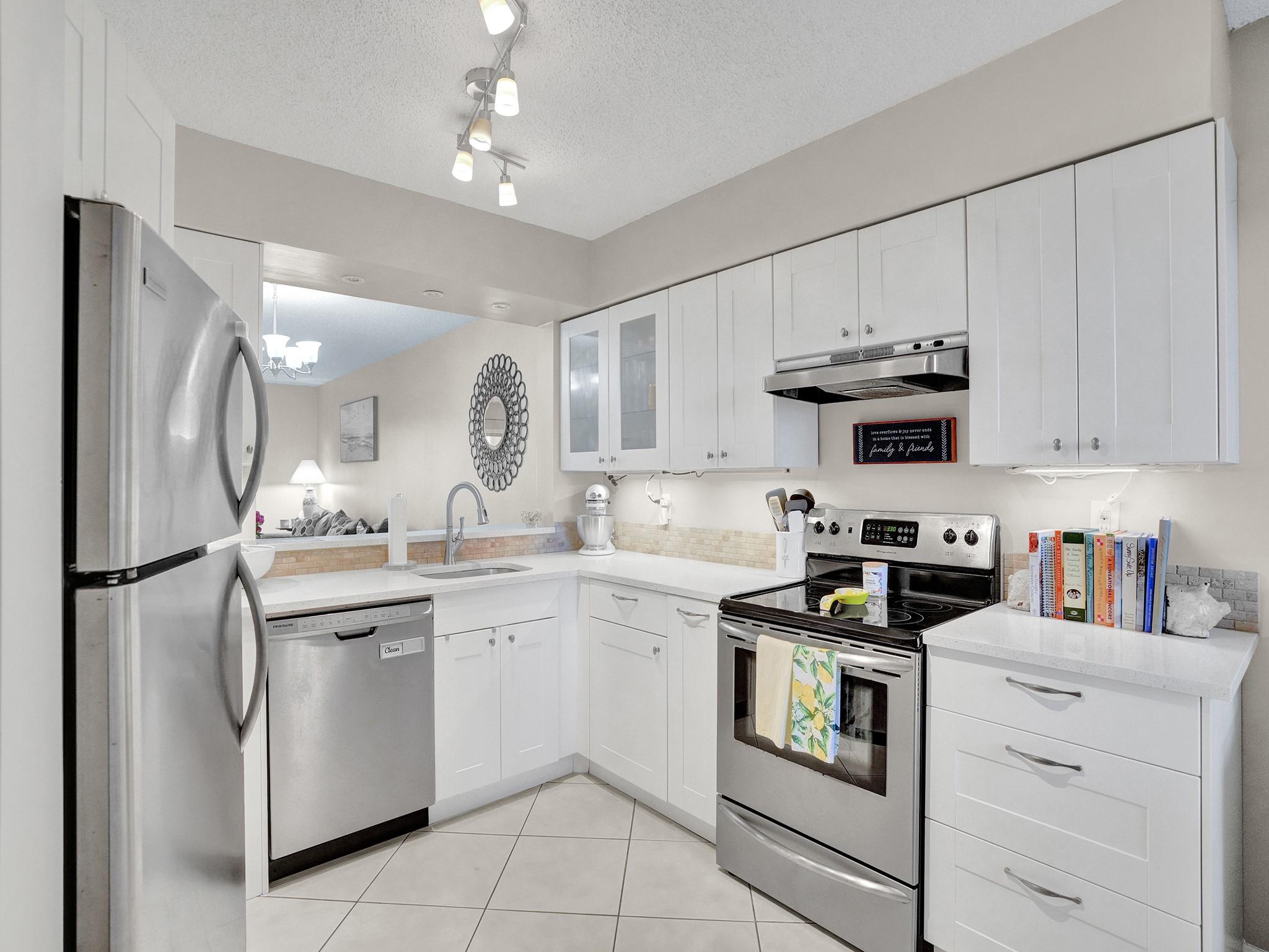 Enjoy resort-style living in this beautiful CORNER unit condo with stunning lake and pool views from your private balcony. The modern kitchen features stainless steel appliances and quartz countertops, plus the convenience of an in-unit washer and dryer. New A/C (2022). This PET-FRIENDLY community offers FULL RESERVES and boasts top-notch amenities including a heated pool, clubhouse, fitness center, tennis, billiards, library, walking/biking path, and more. CABLE & INTERNET included in HOA. External storage included. Lease permitted after 2 years. Unbeatable location! Close to Harrah’s Casino, Top Golf, Publix, dining, golf courses, the beach, and I-95. Association requires 670+ credit score for approval. Two pets allowed (max 20 lbs each).