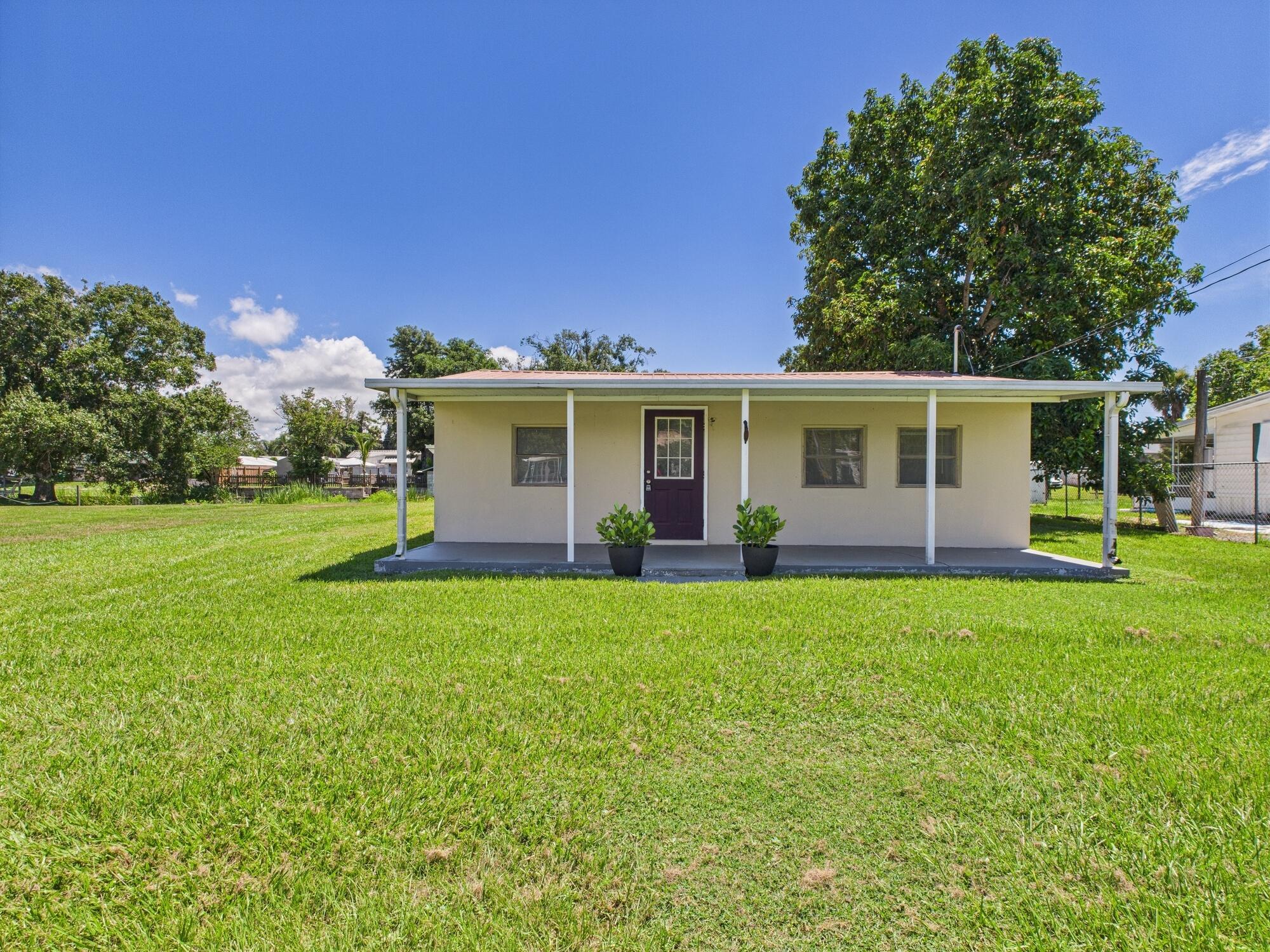 Charming Waterfront Home in Okeechobee Discover serene lakeside living with this delightful concrete block home in Okeechobee, offering direct access to Lake Okeechobee. Featuring a durable metal roof, this 2-bedroom, 1-bathroom residence includes a versatile bonus room that can easily serve as a third bedroom.The property boasts a large detached boat house complete with a garage, fish cleaning station, and boat slip, perfect for boating enthusiasts. Enjoy the tranquility of the peaceful front porch and the lush surroundings provided by mature fruit trees.Experience the perfect blend of comfort and outdoor adventure in this charming waterfront retreat.