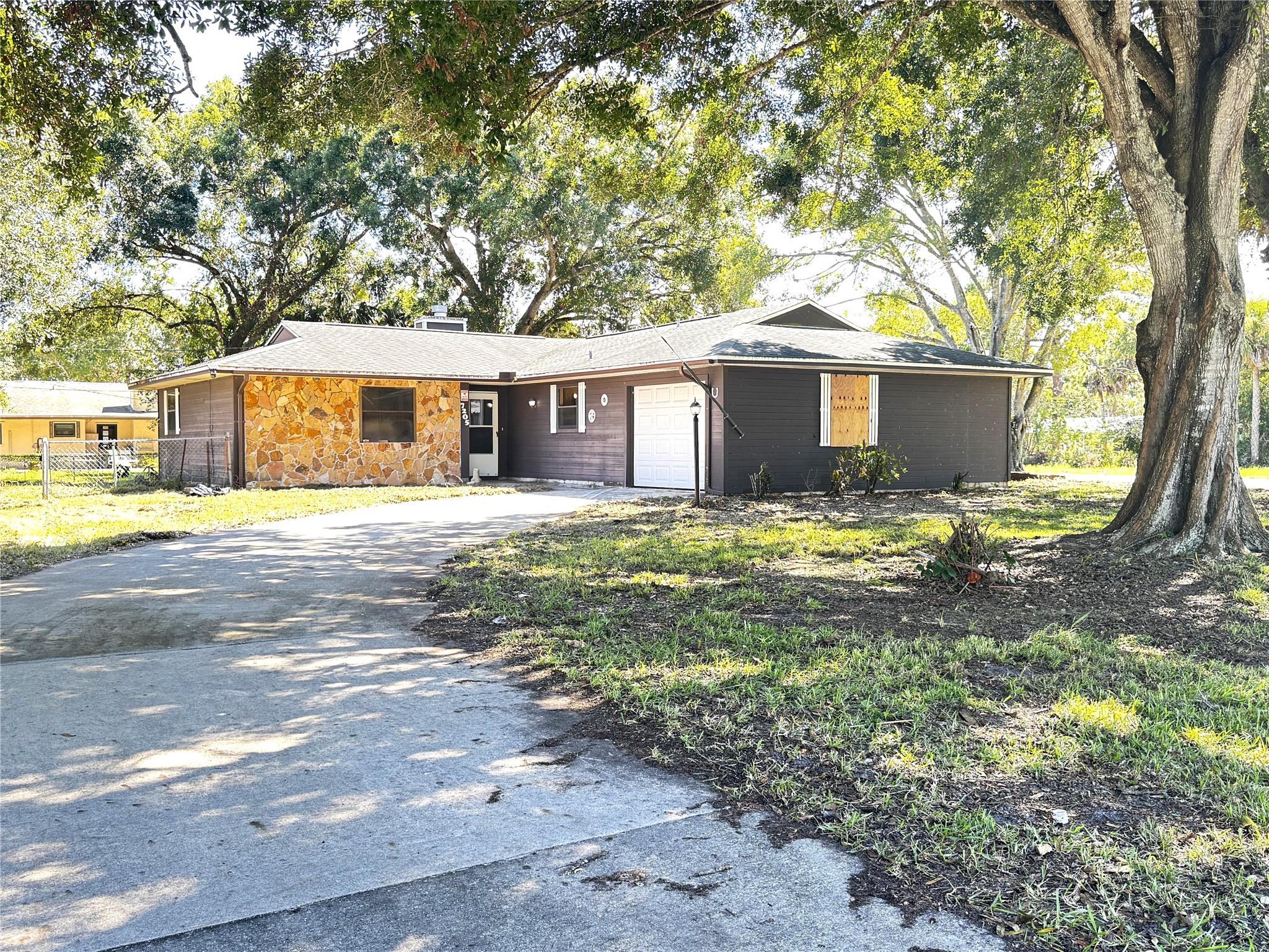 GREAT OPPORTUNITY—Welcome home to your spacious, versatile, and full of charm home! Situated on a corner 1/3-acre lot, this 3 bedrooms, 2 bathrooms home offers an open floor plan with a cozy fireplace, a den/office/additional room, and a screened-in porch perfect for relaxing. Enjoy peace of mind in an enjoyable community of Lakewood Park. New roof (2015), extended driveway and 2-car garage for ample parking. The large yard is ideal for gardening, entertaining, or future upgrades. Perfect as a first home, vacation retreat, or investment property, this home is ready for your personal touch! Close to local Treasure Coast beaches, shopping and dining. Perfect addition to your Real Estate Portfolio!