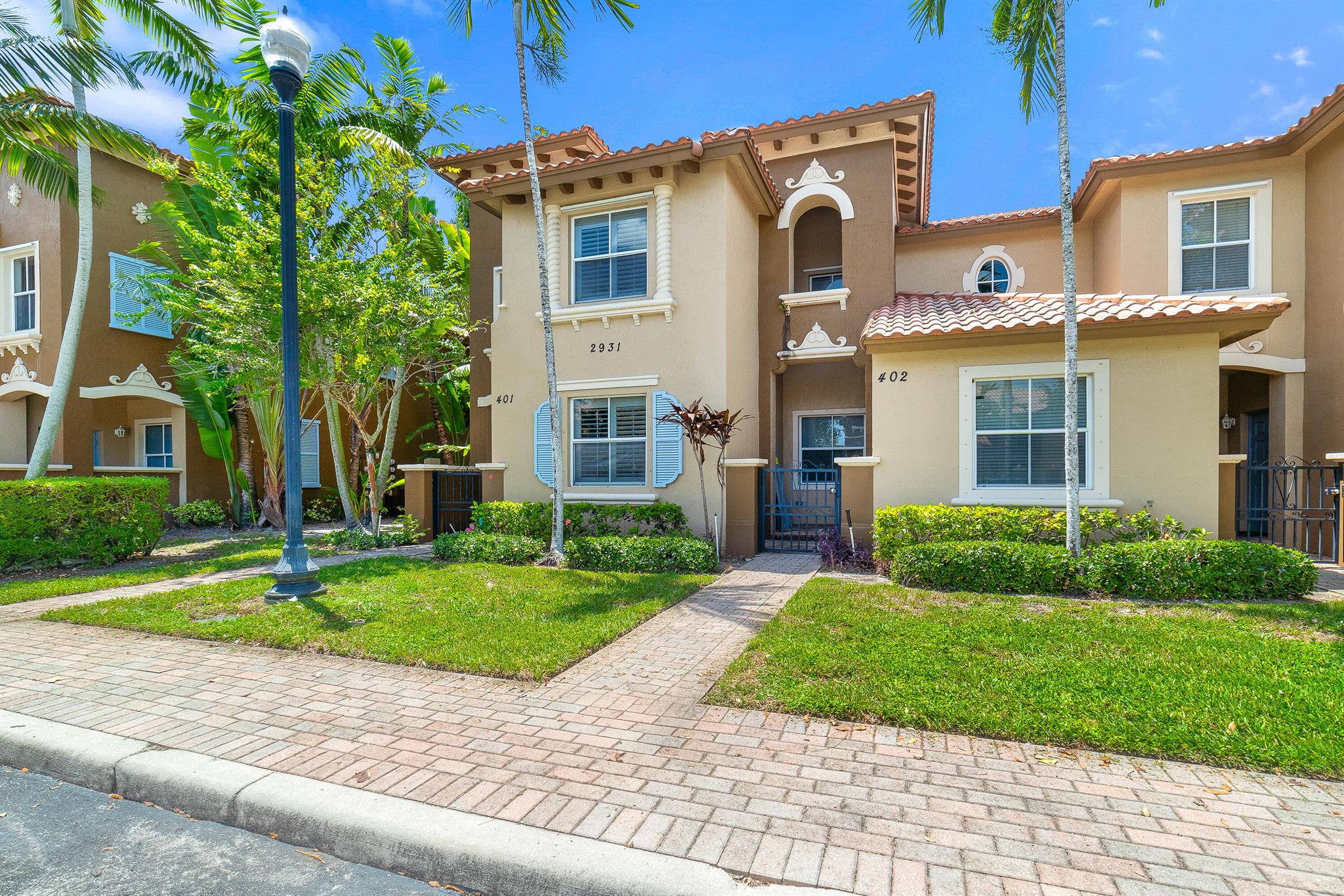 Welcome to The Links at Emerald Dunes in West Palm Beach, a gated community offering the perfect balance of convenience and tranquility. This spacious 3-bedroom, 2.5-bath townhouse features wood, vinyl, and tile flooring throughout, complemented by a formal dining area and family room. The updated kitchen boasts a flattened island with white quartz countertops, a brand-new refrigerator, and modern remote-controlled ceiling fans and power outlets. Natural light floods the interior, creating a bright and peaceful atmosphere. Additional updates include a new toilet in the downstairs bath and panel shutters for peace of mind. Upstairs you'll find three comfortable bedrooms, including a private primary suite with its own private covered balcony.
