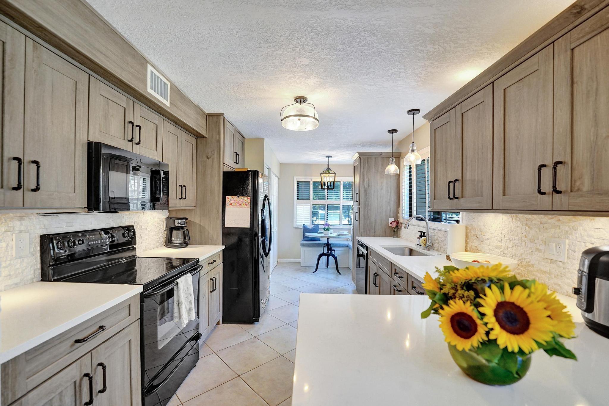 COMPLETELY UPDATED CORNER APARTMENT LOCATED IN PRIVATE PINE ISLAND RIDGE CC. 1ST FLOOR LOCATION * STEPS FROM YOUR PARKING SPOT PROVIDES EZ ACCESS * SPACIOUS UNIT WITH ALL IMPACT WINDOWS * UPDATED & UPDATED KITCHEN & BATHS* BLACK APPLIANCES* NEW TANKLESS WATER HEATER * PANTRY CLOSET PROVIDES ADDITIONAL STORAGE * NEWER CARPETING IN BEDROOMS * KITCHEN TABLE & DININGTABLE/POOL WILL STAY* SERENE GARDENS VIEW * AMENITIES INCLUDE COMMUNITY POOL*THIS APARTMENT IS LOCATED IN PRIVATE PINE ISLAND RIDGE COUNTRY CLUB, WHICH OFFERS AMENITIES SUCH AS GOLF TENNIS SAUNA STEAM WORKOUT FACILITY SPORTS BAR AND PRIVATE DINING ROOM. NSU AND DAVIE COLLEGES 10 MIN. PRIVATE COUNTRY CLUB COMMUNITY * EXECUTIVE GOLF COURSE * TENNIS*PICKLEBALL, BOCCE BALL * GYM, SPORTS BAR * FINE DINING ROOM * ROOFS REPLACED 2021*