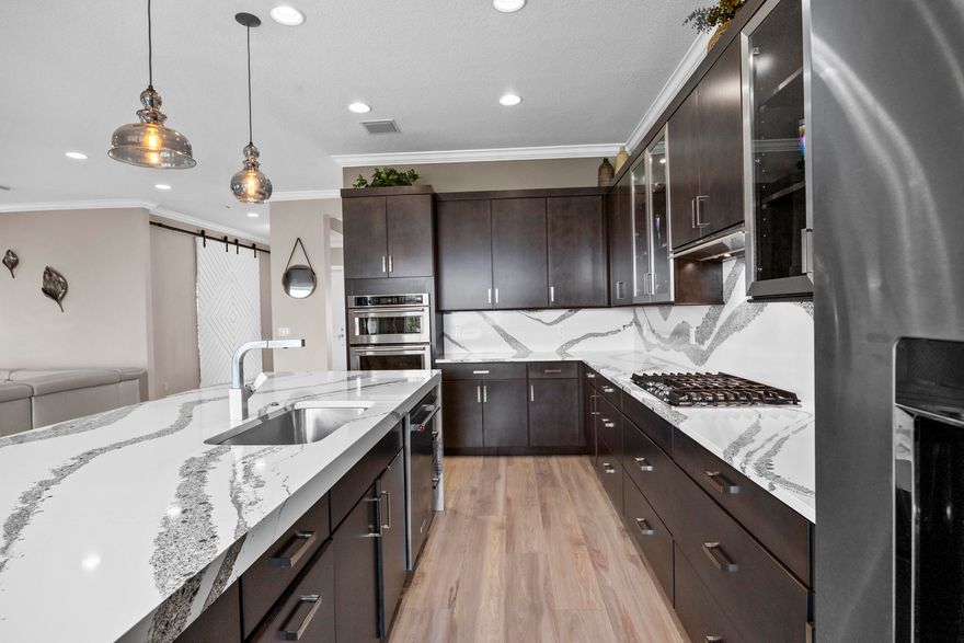 Skip the builder timeline and extra out-of-pocket costs with this 2021 Kenco-built lakefront home offering nearly 4,000 sq ft of move-in ready living. Soaring ceilings and natural light fill the space, anchored by a chef's kitchen with a large waterfall quartz island and gas range. Upgrades are already complete, including designer lighting, custom window treatments, and new flooring. A main-level ensuite bedroom plus an upstairs loft creates flexible living options. The rare 4-car garage sets this home apart. Step outside to a covered lanai with outdoor kitchen and a pool-ready backyard with new renderings available. Exceptional value in Arden without the wait.  Why build when perfection is ready today? Arden is South Florida's premier agrihood, offering a lifestyle that stands apart from anything else in the area. At the center of the community is a 5 acre working farm, where residents can enjoy fresh produce and seasonal harvests. Miles of scenic trails wind throughout, creating space for morning runs, evening walks, and time outdoors.  The amenities rival a private resort, featuring a striking two level pool with cascading waterfalls, a fully equipped fitness center, and a clubhouse that brings neighbors together through events and shared experiences.  Set along a 176 acre lake, Arden was designed for those who value space, fresh air, and a true sense of connection. All of this just minutes from Wellington's equestrian venues and the shopping and dining of West Palm Beach. Homes like this offer an opportunity to step into this lifestyle now, without the timeline or uncertainty of building.
