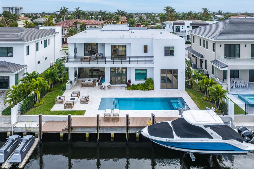 Introducing 799 NE 20th, a Contemporary Marvel Nestled in the Coastal Oasis of Boca Harbour.

Step into luxury with this exquisite modern waterfront home, gracing 80 feet of prime water frontage in the sought-after Boca Harbour community. Immerse yourself in a resort-style backyard that defines tranquility, featuring an expansive covered loggia, a meticulously designed saltwater pool and spa, and a 20,000 LB boat lift for boating enthusiasts.

As you enter, the home welcomes you with a thoughtfully designed floor plan that seamlessly blends open-concept living with an abundance of natural light. The first floor boasts a bespoke kitchen equipped with natural gas, offering breathtaking views of the backyard and living room. Discover the convenience of a first-floor bedroom suite wit an ensuite that doubles as your private cabana bathroom.

Ascend the stunning floating staircase with glass railings to the second floor, which is also elevator-ready for those seeking elevated convenience. Revel in the natural white oak flooring that graces the loft and four bedrooms. The Primary suite is a spacious retreat, featuring a private covered balcony with a captivating fire featurean ideal space for enjoying early morning sunrises.

Indulge in the opulence of the master bathroom, adorned with custom cabinetry, a massive shower, and a freestanding tub, creating a sanctuary within your own home. Enjoy peace of mind with the homes Whole-home storm generator, ensuring continuous power for this modern waterfront retreat. Live in the lap of luxury in Boca Harbour, one of Boca's most prestigious boating communities, just minutes away from renowned amenities such as The Boca Raton, Mizner Park, and Downtown Delray. Seize this opportunity to call this modern marvel your waterfront haven.