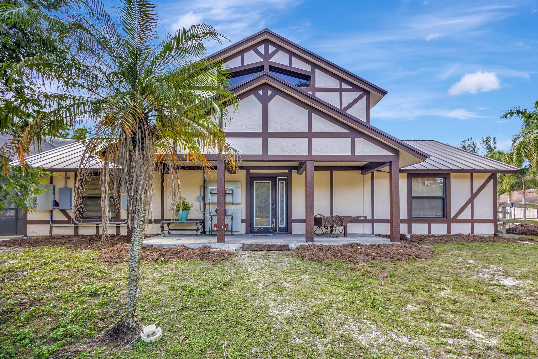 Where can you live in Palm Beach County on a quiet peaceful road? Dellwood Road !.All 3 oversized bedrooms have full ensuite baths.Upstairs primary suite is spacious and cozy with a walk in closet, luxurious spa tub, and twin shower wet room with His and Hers vanities.Relax in the heart of the house with an open plan kitchen and dining area, separated by a stone dual-sided fireplace. Off the kitchen is an attached 27x12 art/hobby space , or convert to an additional bedroom.Outside, cool off in a full salt system pool with a tanning shelf and spa, including a summer kitchen and grill.Outside is a 7 stall, 40x60 barn with 12x12 stalls, paddocks, and 2 wash racks. Spacious fenced 90x200 riding arena with sand footing. The property is fenced and cross fenced with 3 paddocks.. A 56x21