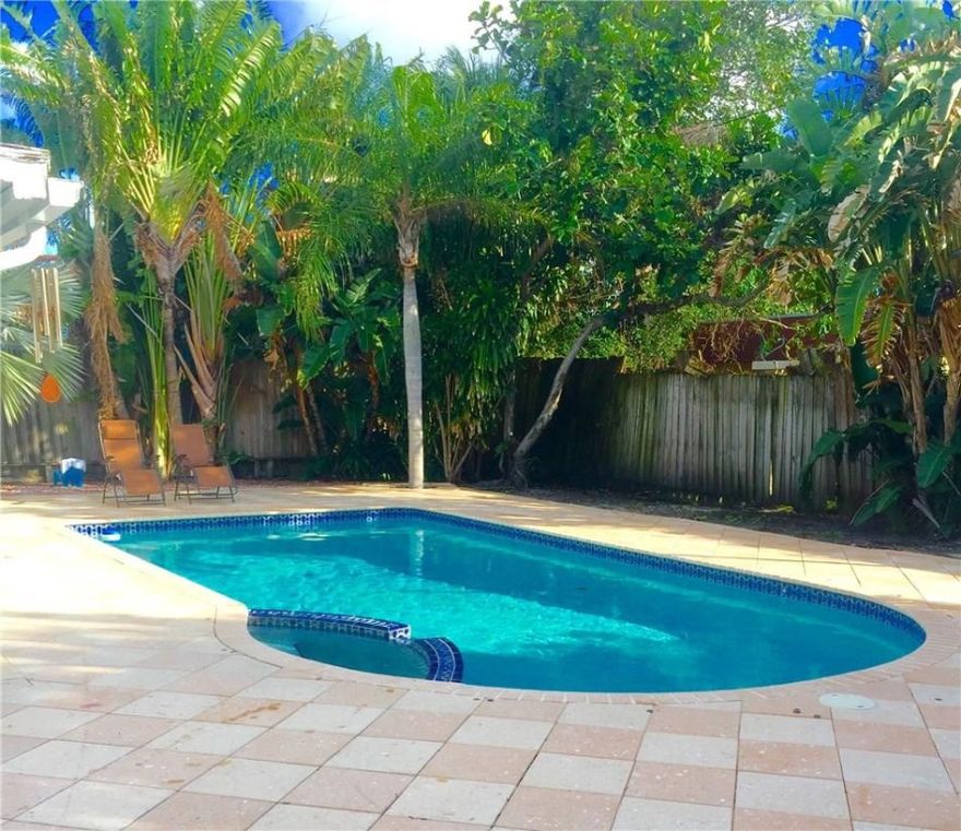 The most attractive single family home with a POOL east of Federal Hwy for the price. 2/2 with an extra sun room to go with your  large pool surrounded by ample area for entertaining friends and family. Stylish white and gray tile throughout and hurricane impact windows and sliding doors. Brand NEW kitchen and NEW Samsung appliances including  full size washer and dryer. Renovated bathrooms with rain head showers. All that and only 1/2 a mile from the beach! How can you not love this? Welcome Home!