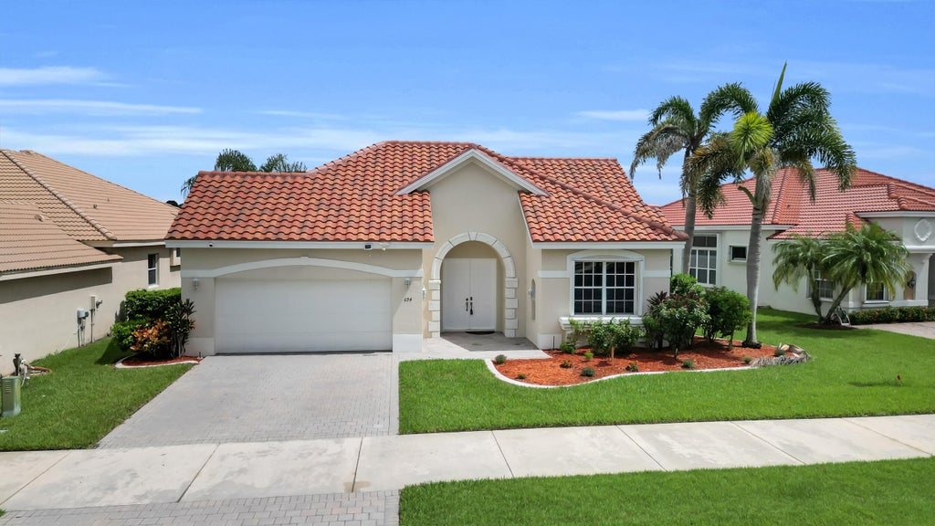 Photo of 694 SW Lake Charles Circle, Port Saint Lucie, FL 34986 (MLS # B26077675)