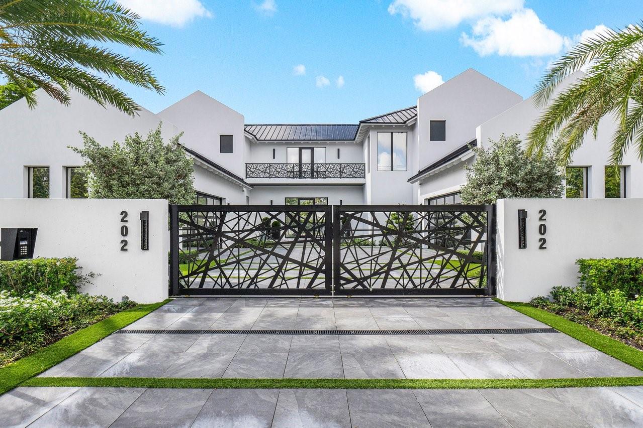 This brand-new, meticulously designed residence built by Azure Development blends sophisticated design, custom details, and superior craftsmanship in the heart of Delray Beach’s coveted Lake Ida neighborhood. Crafted for seamless indoor-outdoor living, the home features five spacious bedrooms and an open-concept layout filled with natural light. Inside, soaring ceilings with European white oak floors, and bespoke finishes. The Eggersmann kitchen is a culinary showpiece with Miele appliances and a custom German marble island with a black oak dining table. The primary suite offers a private sanctuary with a balcony, steam shower, and Italian porcelain finishes. Outside, the landscaped backyard features a sunken firepit, covered loggia, and sleek LED pool, creating a private oasis of luxury.