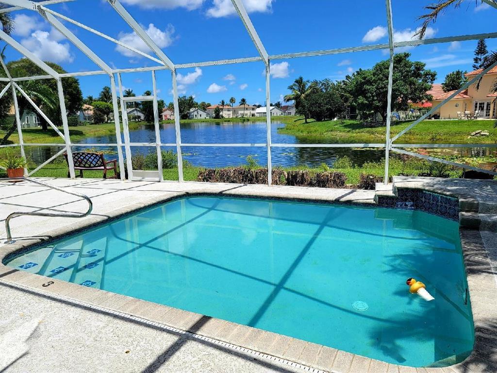 Rarely available The Estates- Windchime Lakes, don't miss your opportunity! Highest rated schools for all grades. BRAND NEW ROOF!! Soaring ceilings, screened in pool with summer kitchen and outdoor shower featuring long lake views and beautiful sunrises. A/C less than 1 year old and brand new Hot Water Heater. Full accordion shutters for added piece of mind. All ready for your personal touches.