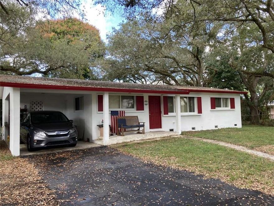 Non HOA property! 3/2 with a carport on a 9/10th of an acre of land. Surrounded by 20 oak trees and has 3 mango trees that produce wonderful fruit.. The property is fenced and perfect for children and animals. Hurricane impact windows and doors were installed a year ago, driveway repaved and treated for 10 years, air conditioner is less that 6 months old, water heater - 3 months. Freshly painted inside and out 1 month ago and the wood floors throughout the house were refinished 2 months ago.  It is located 10 minutes from the Fort Lauderdale International Airport and Port Everglades. Located within walking distance of the Hard Rock Hotel and Casino, elementary and high school. I-95, I 595 and the Turnpike are all within a 5 minute drive. 10 min to Hard Rock Stadium and 15 min to the beach.